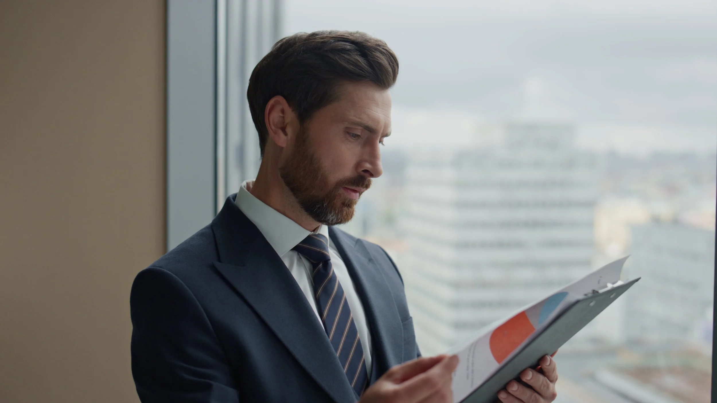 A person in a suit reviewing a compliance document, with a look of confidence.