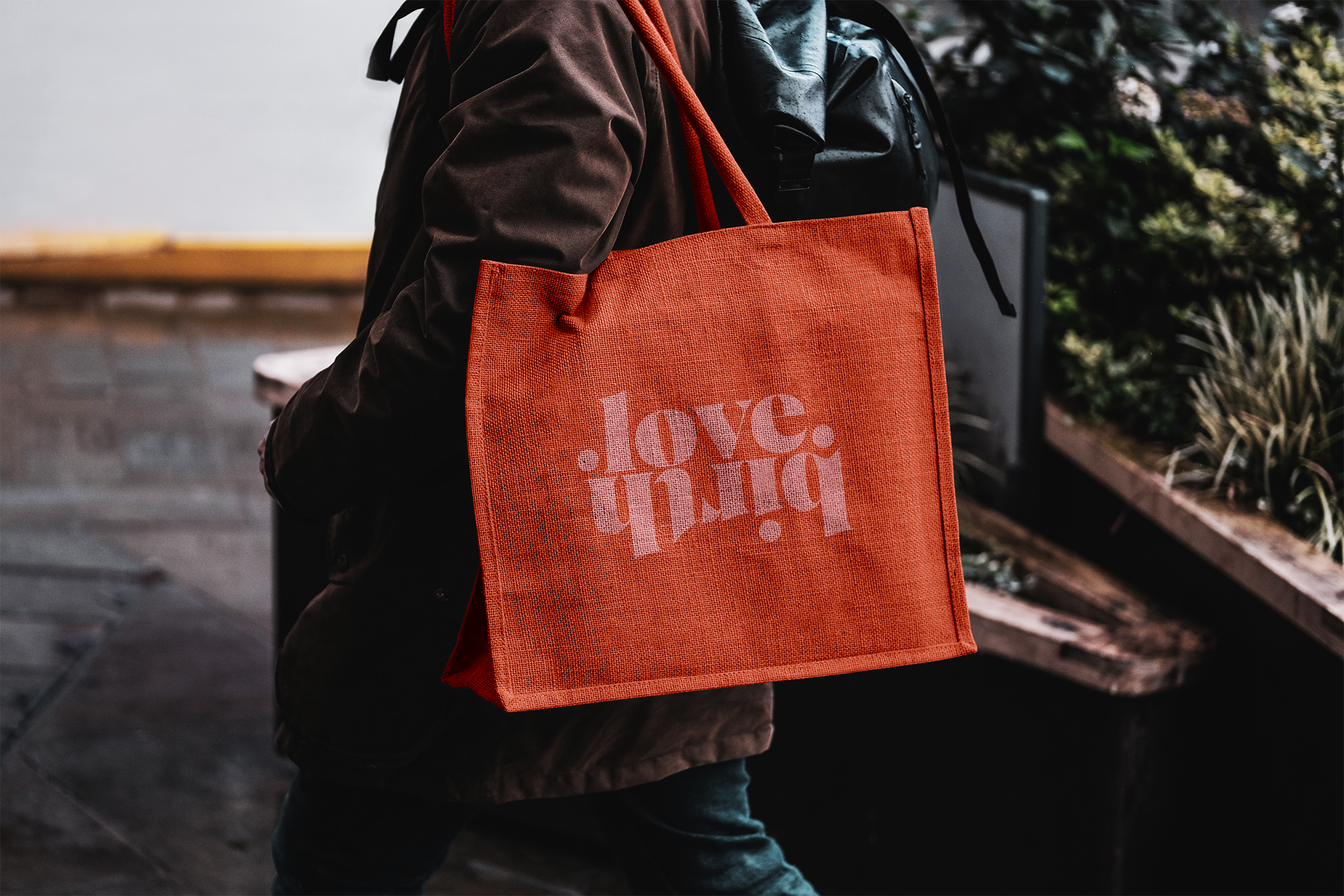 Free Eco Bag Carrying by Man Mockup.png
