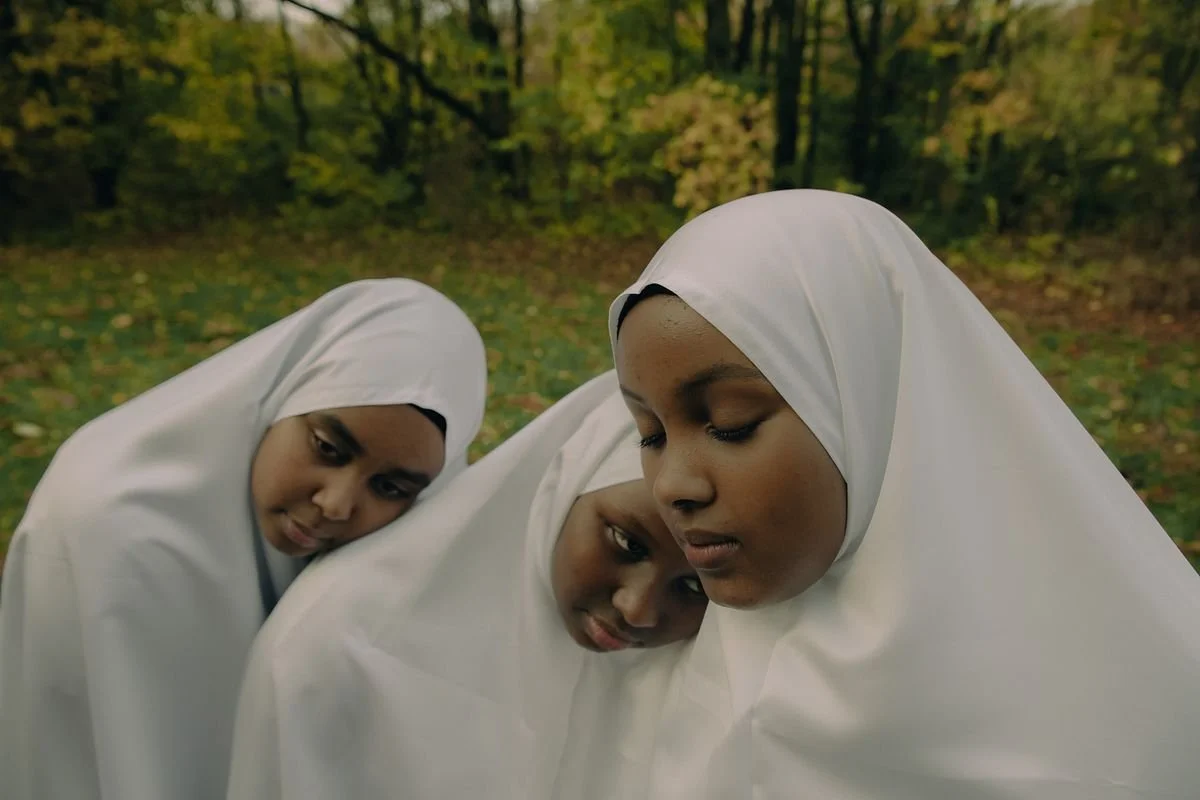 Three somali girls in white jibab standing close to each other