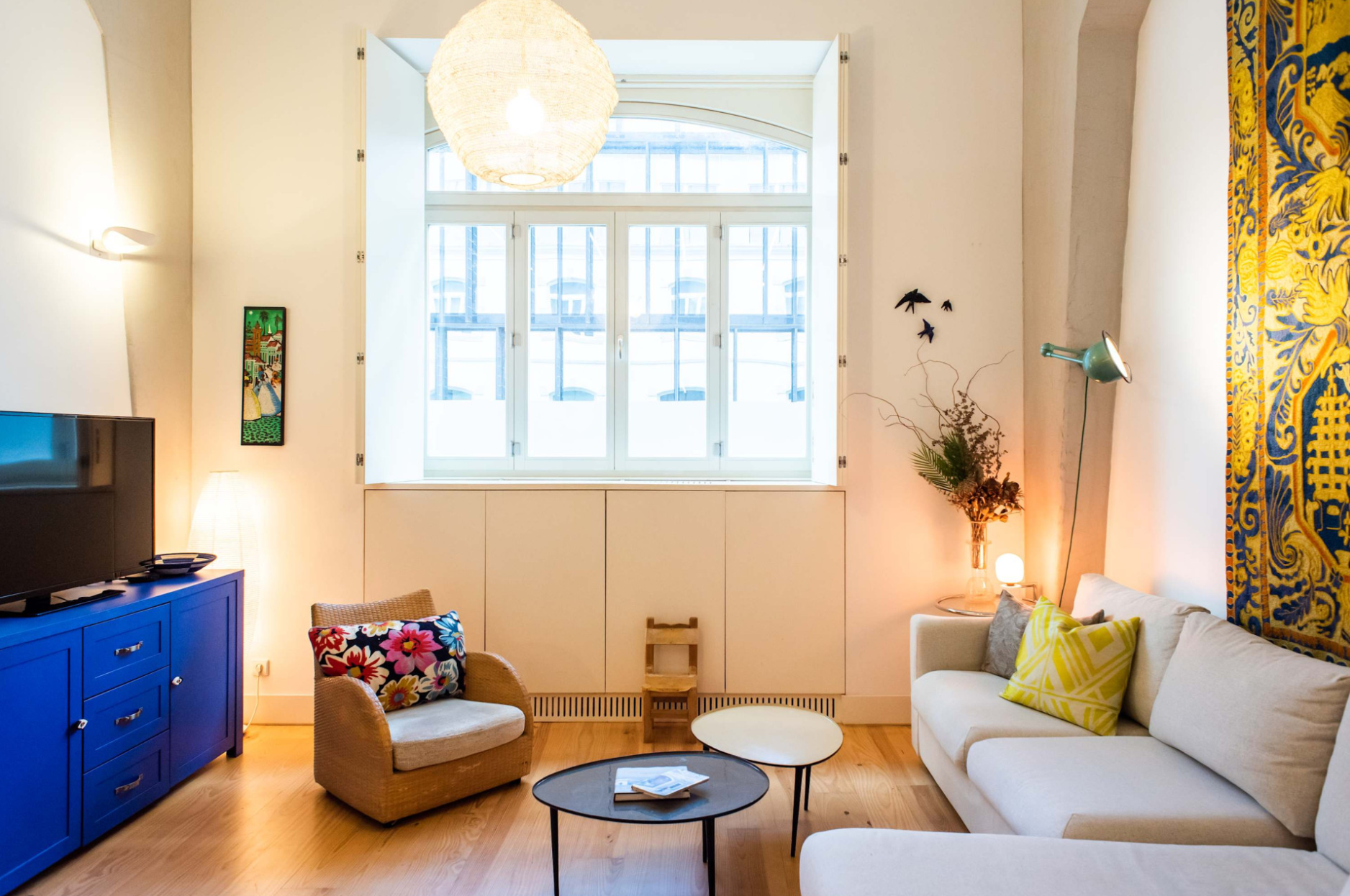 Colourful Lisbon living room with patterned cushions and azulejo tile hanging, Curated Property holiday let in Lisbon