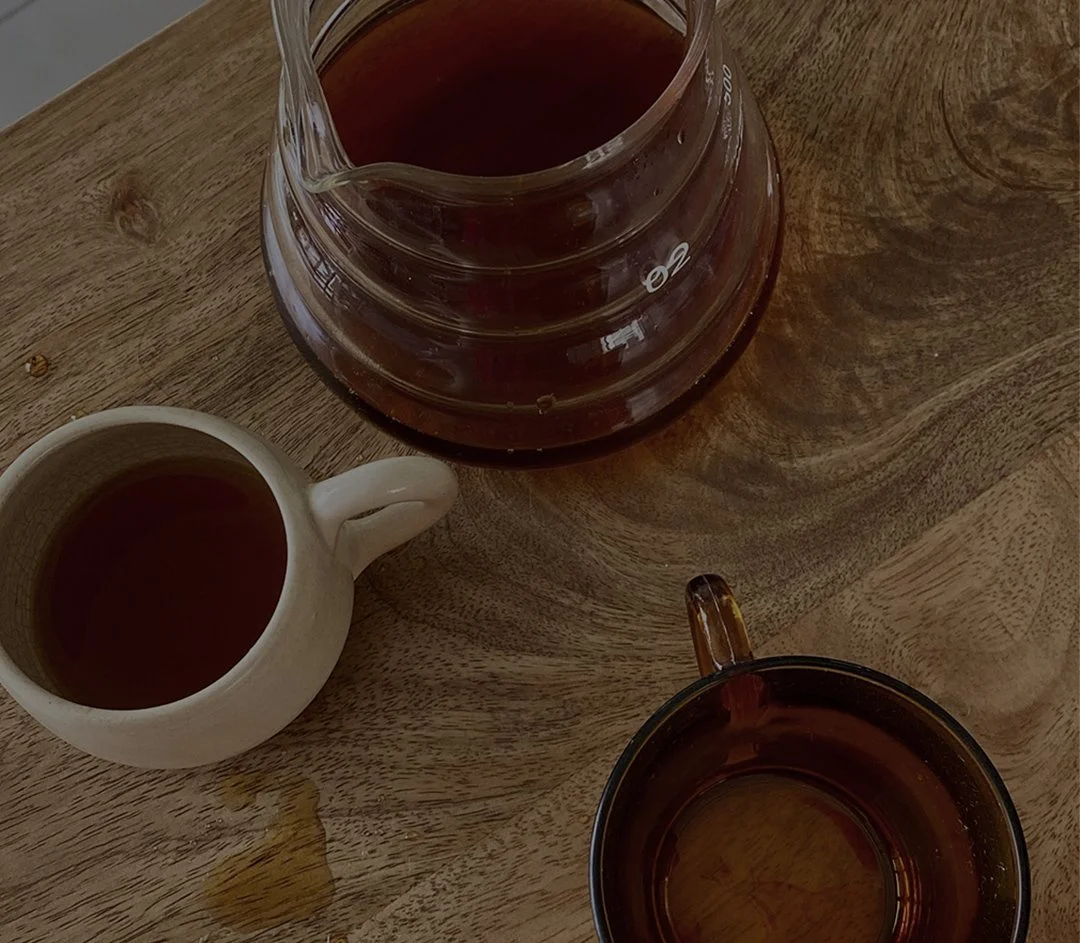Warm cups of tea on a wooden table representing a quiet moment to rest in God and find peace.
