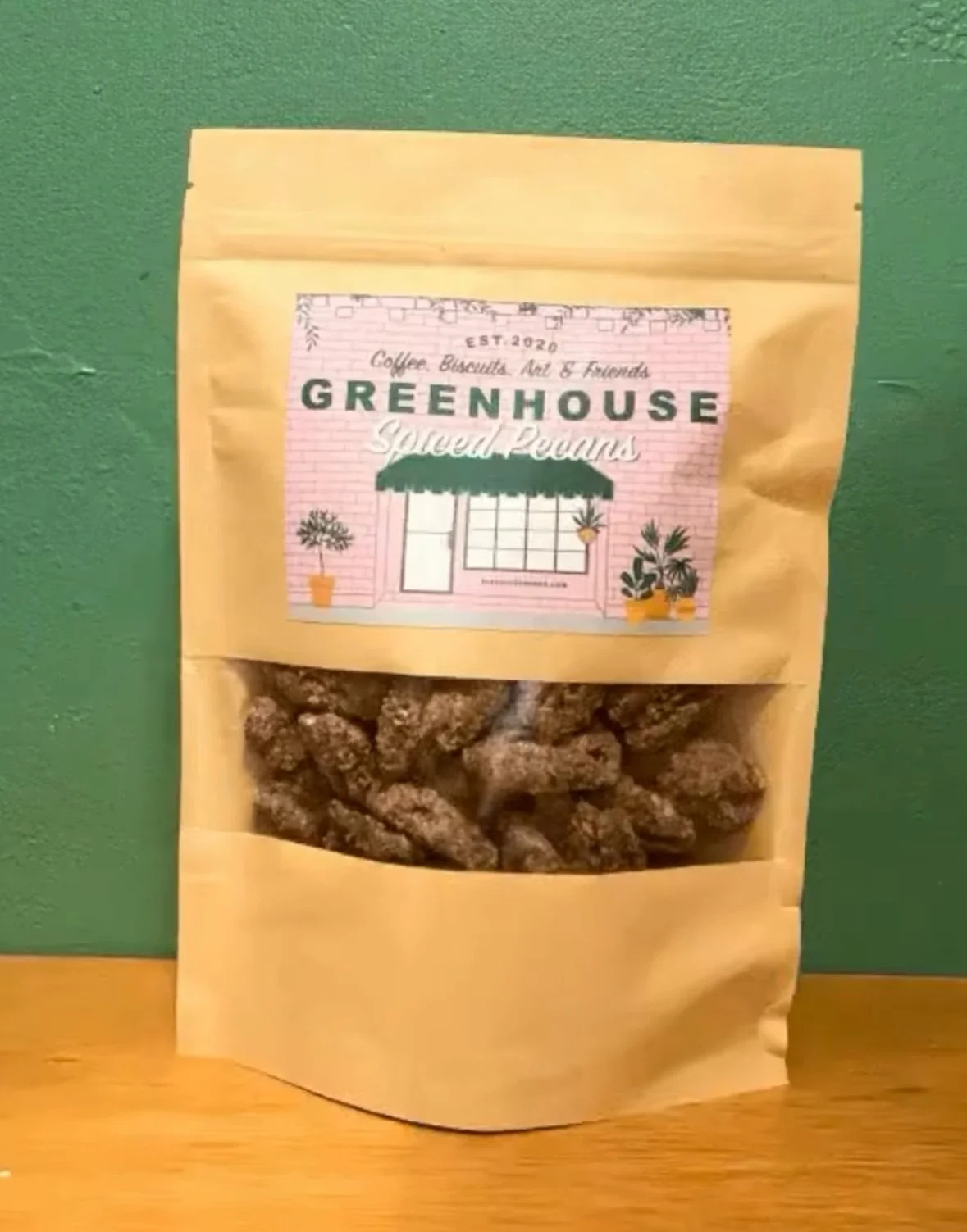 A brown paper bag of Spiced Pecans from Greenhouse (Biloxi, MS). Prime Pecans are exclusively used in this product.