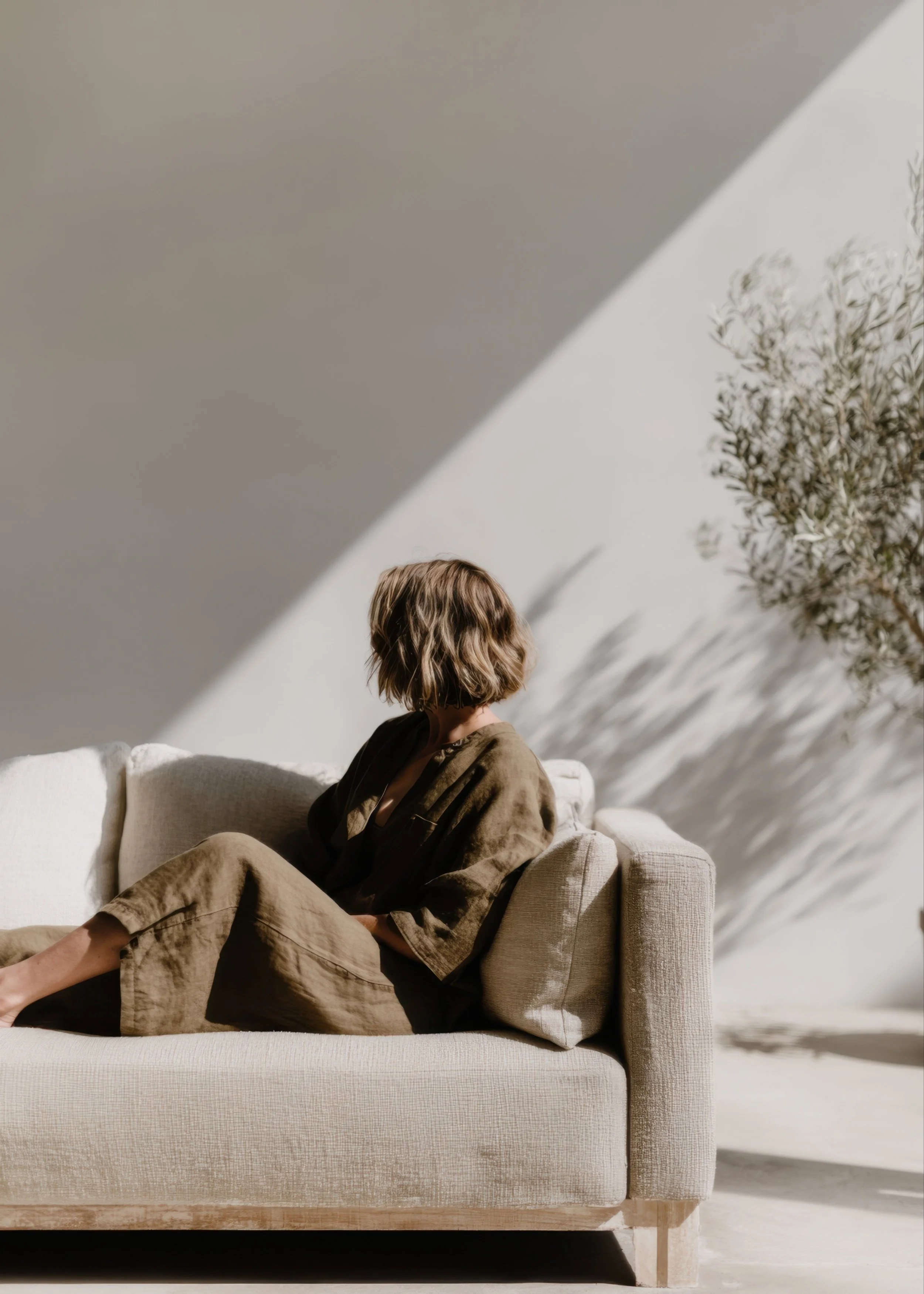 Person sitting in a sunlit therapy space