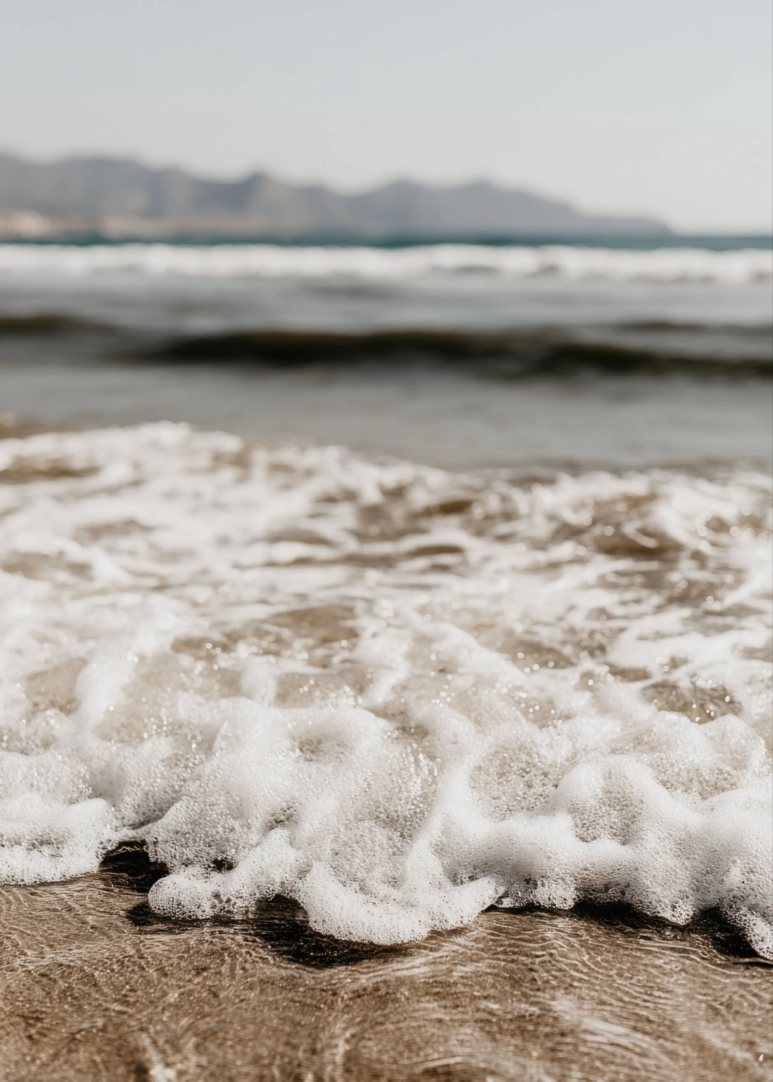 Ocean waves washing onto a sandy beach in Redondo Beach, CA