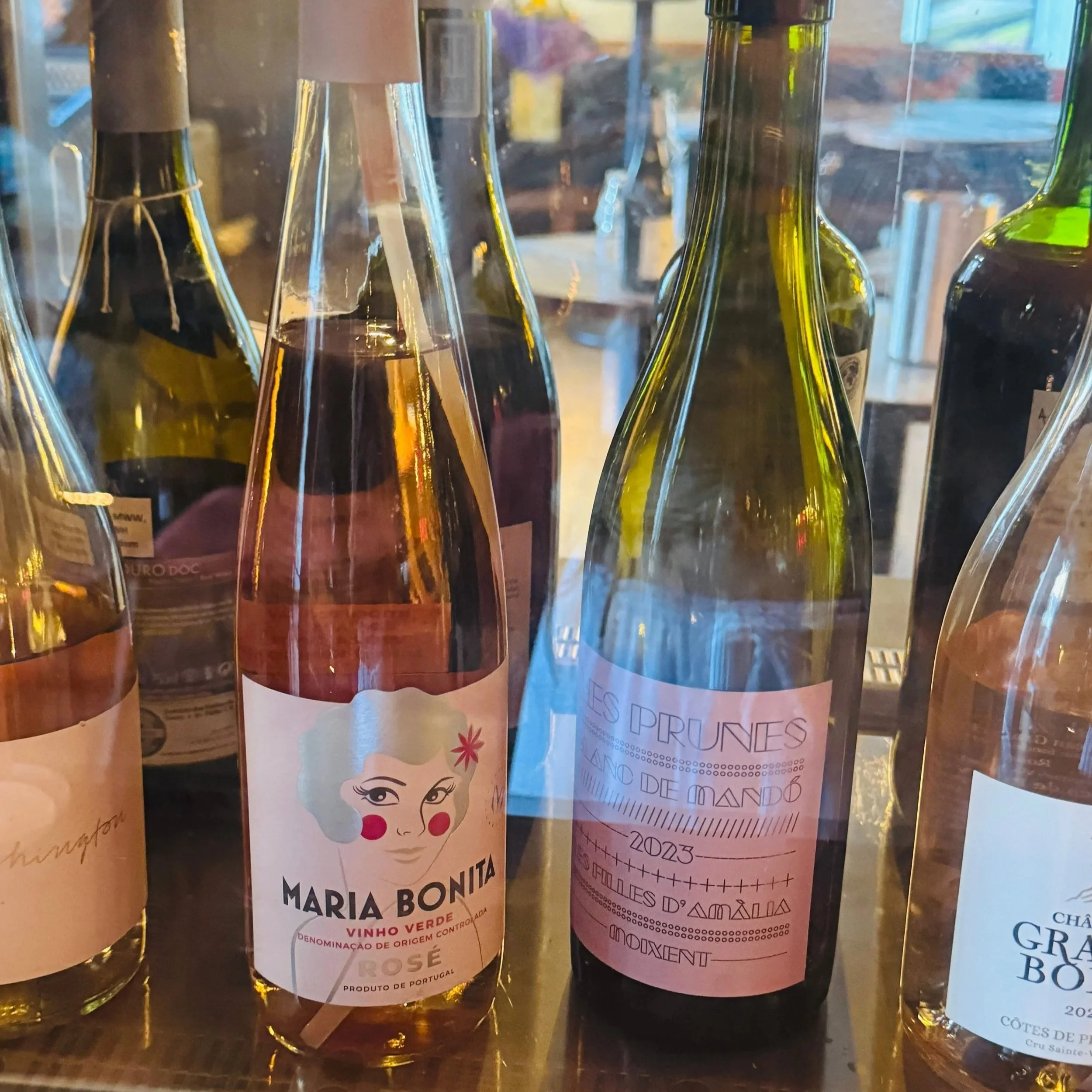 A collection of wine bottles elegantly presented in a glass display case.