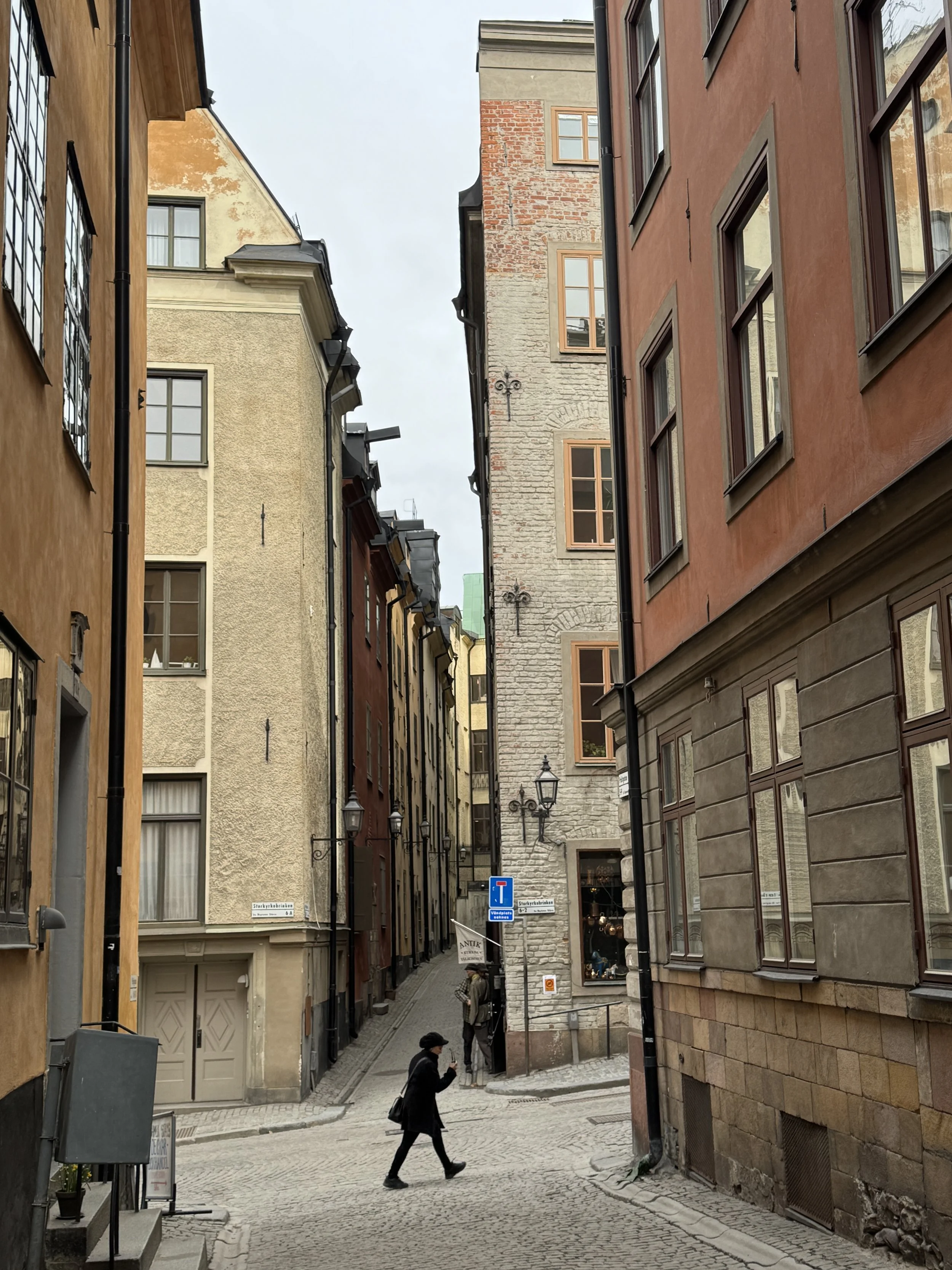 A person walking through the streets of Gamla Stan in Stockholm