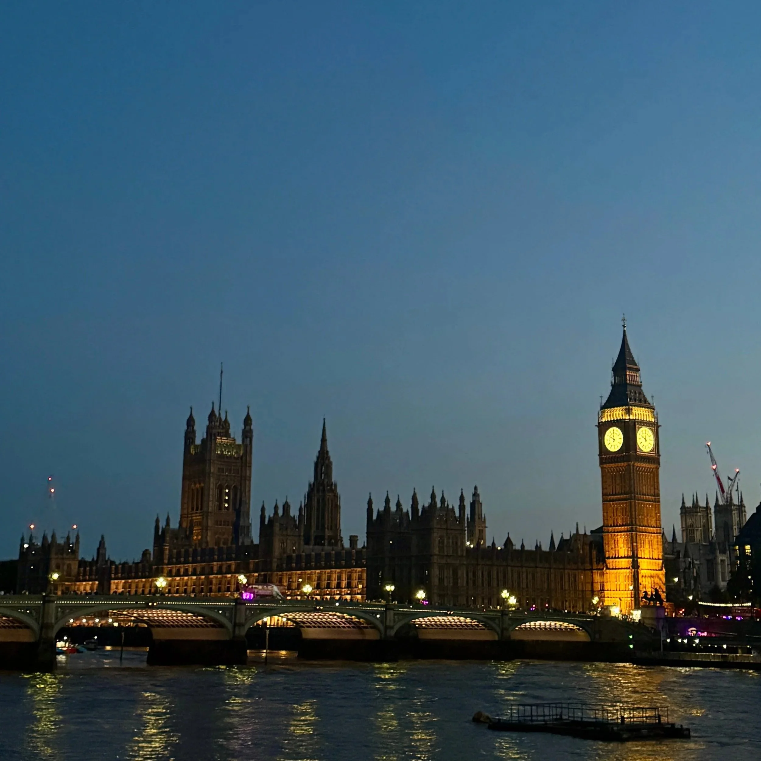 Iconic view of Big Ben and the Palace of Westminster, showcasing London's historic architecture against a clear blue sky.