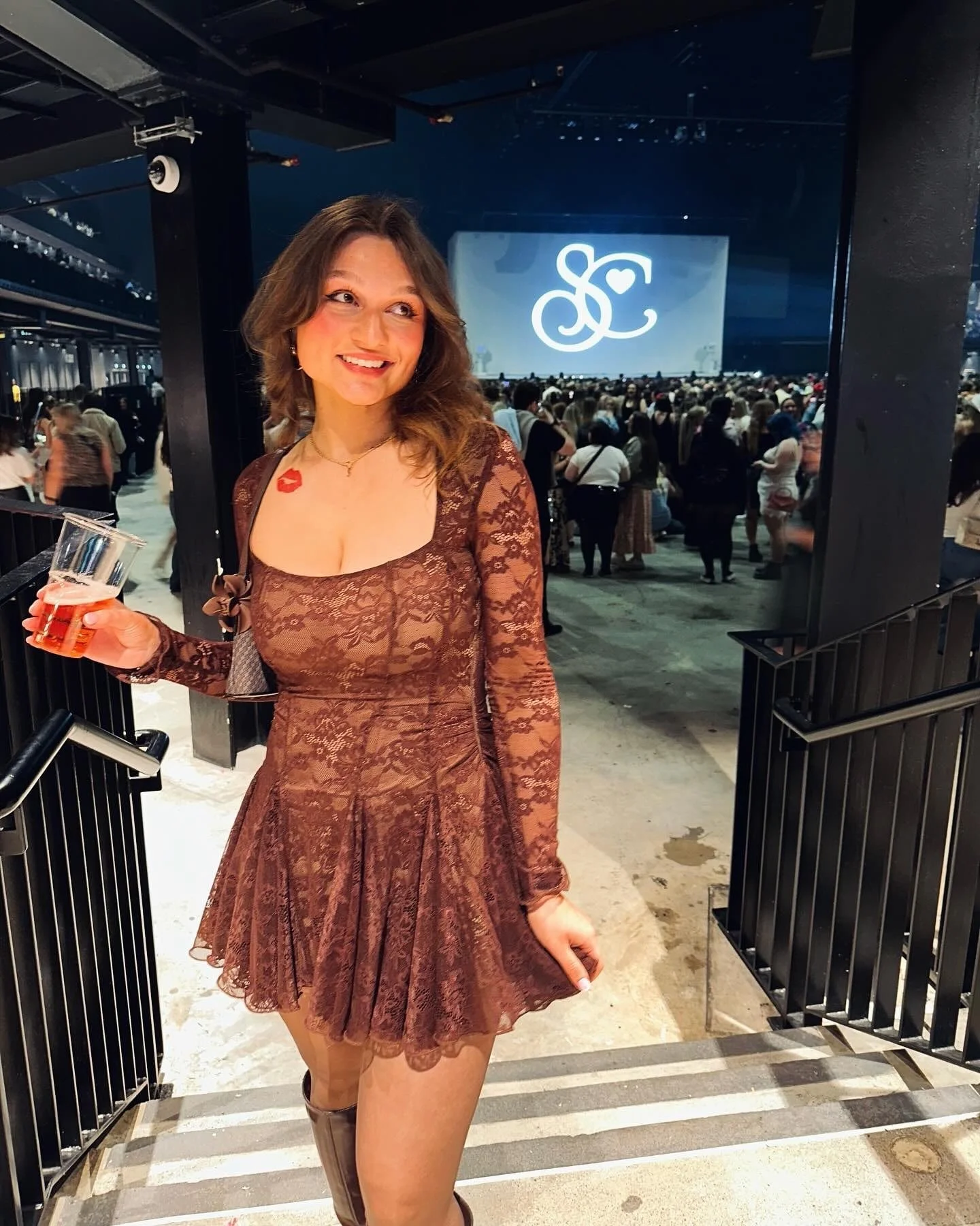 A woman at the Short'nSweet concert wearing a lacy brown dress
