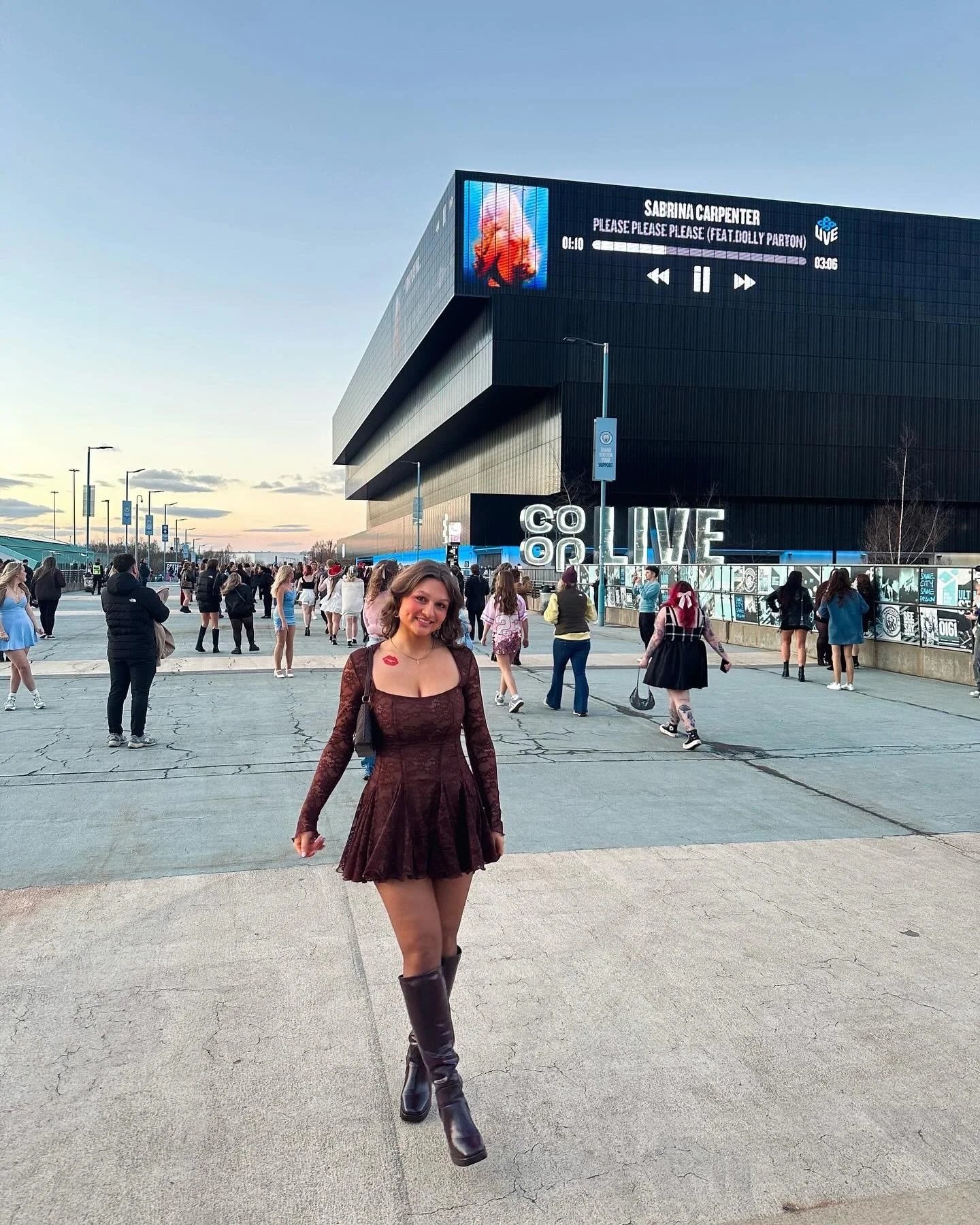 A woman standing outside of the Co-op Live in Manchester at the Sabrina Carpenter concert