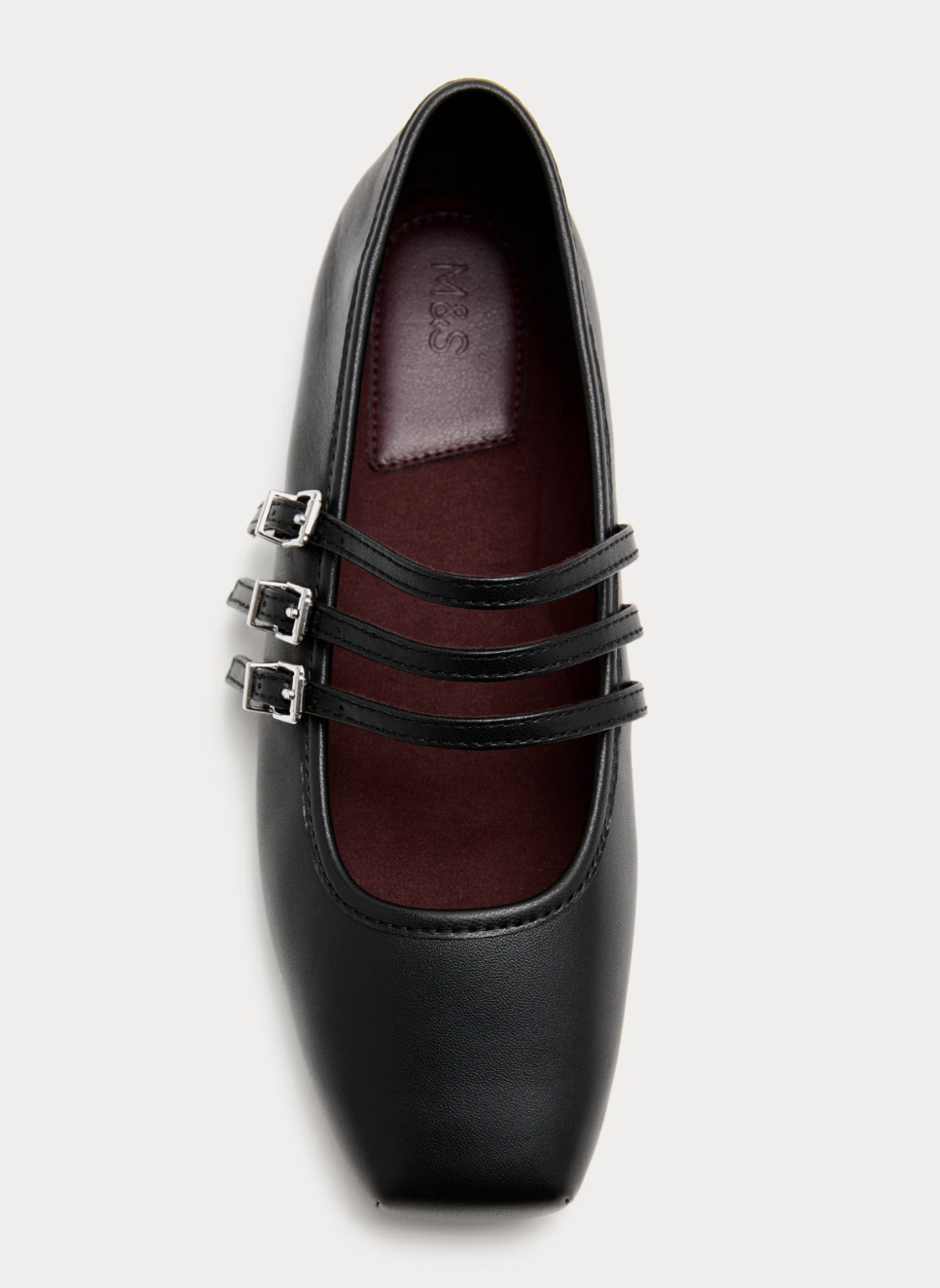 Black flat shoe with three thin straps and silver buckles, featuring a dark red insole and square toe. Clean, elegant design on a white background.