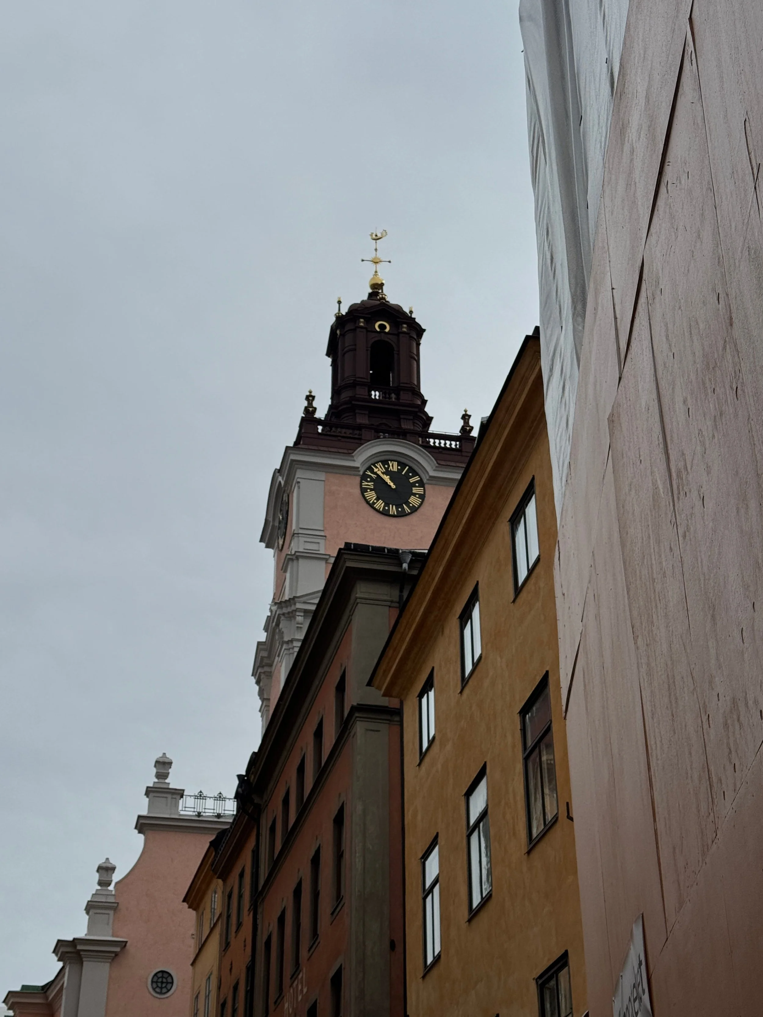 A colourful clock tower in the heart of Gamla Stan in Stockholm