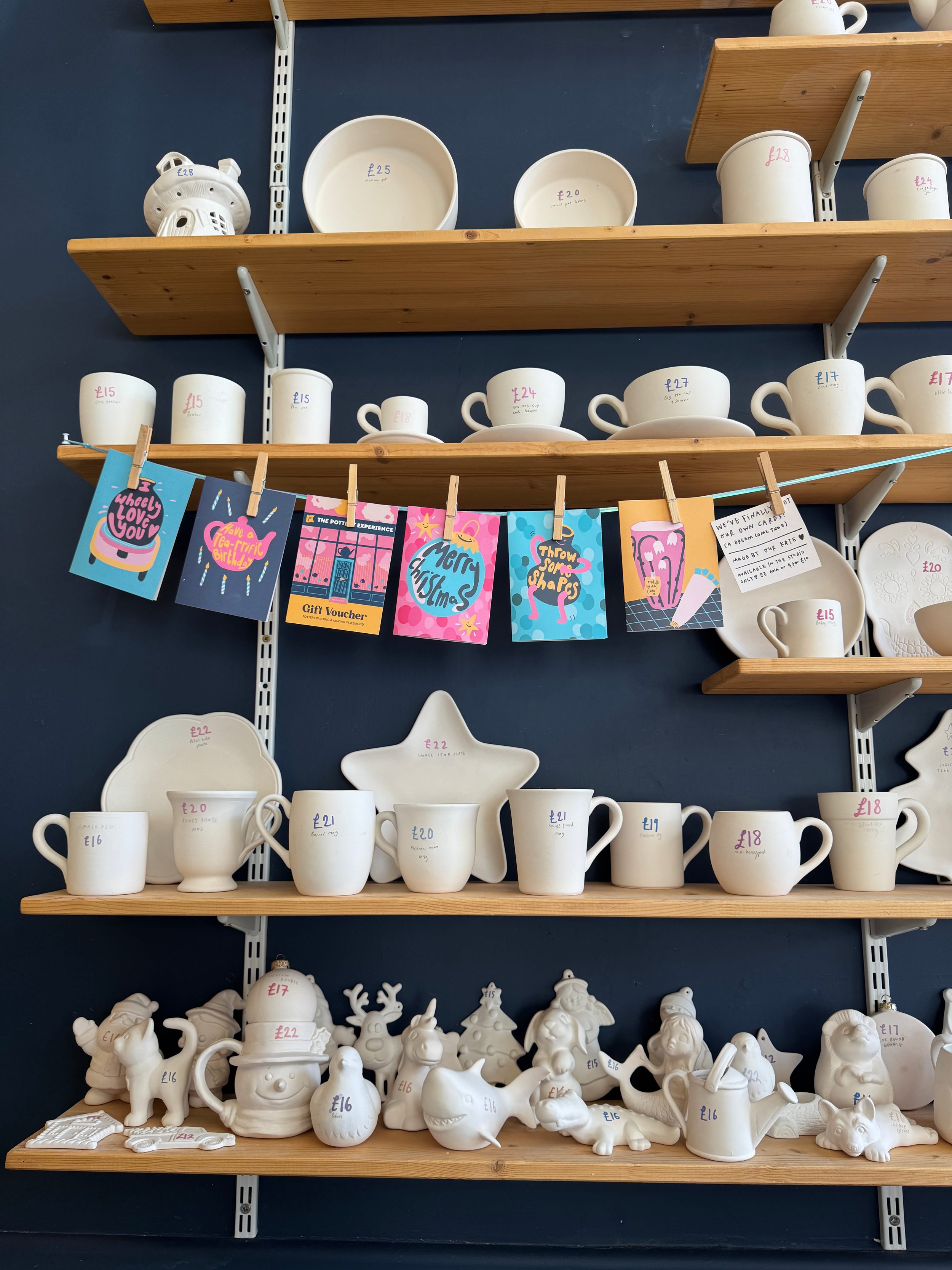 The shelves of mugs and plates and ceramics at the Pottery Experience in Jesmond.