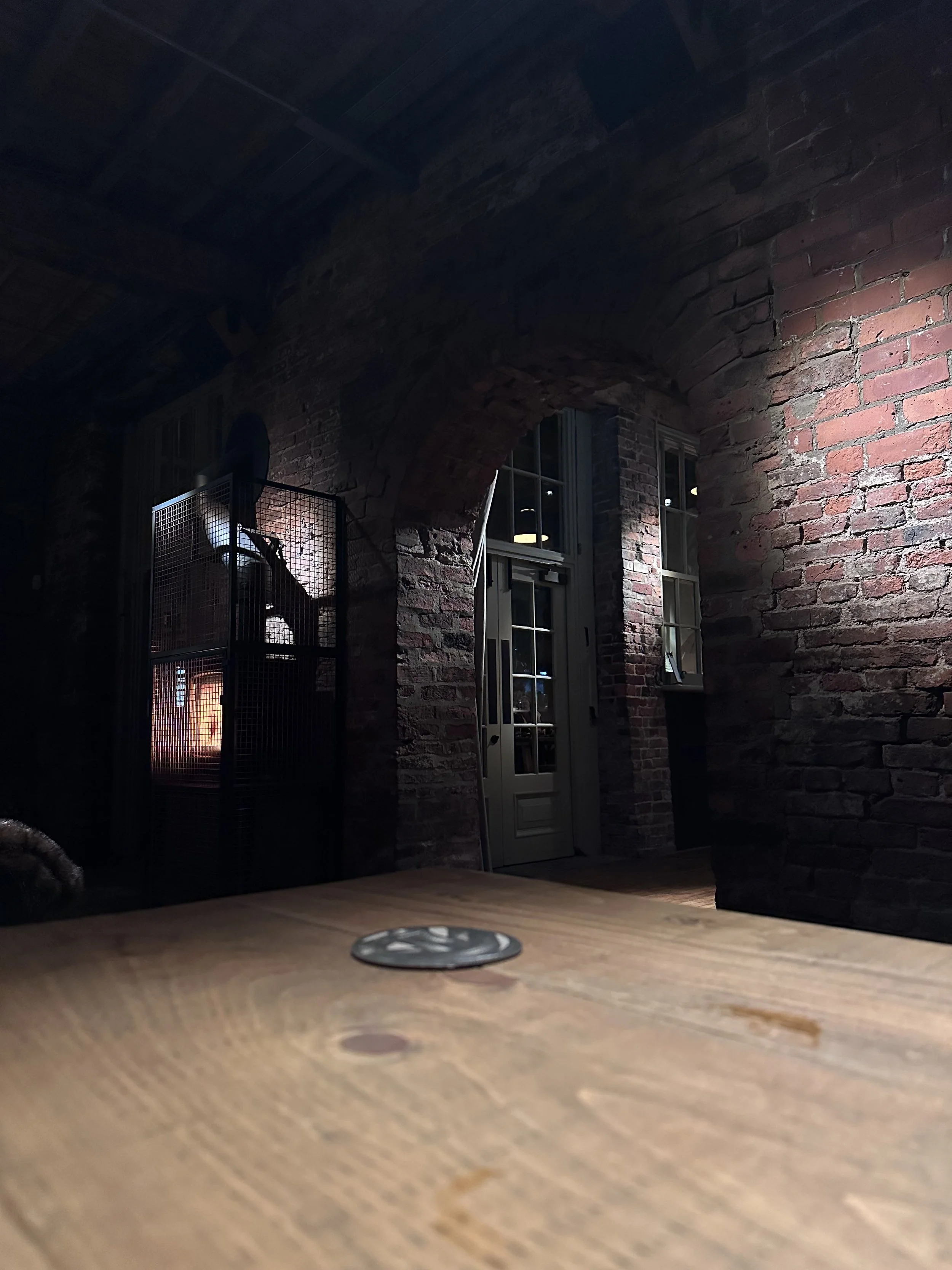 A pub interior featuring redbrick walls and a log burner