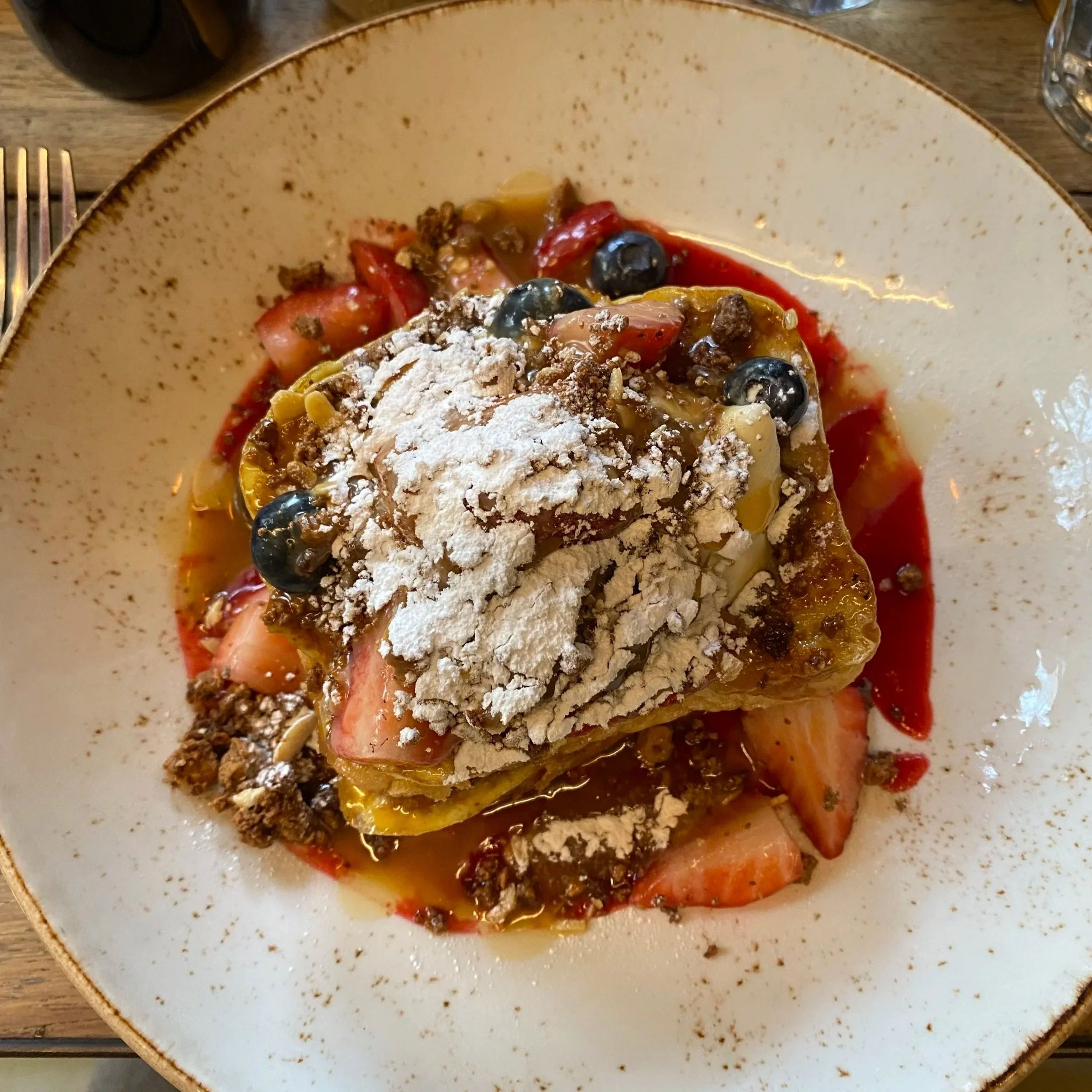 A plate of French Toast served at Federal Cafe, topped with berries and marscapone cream