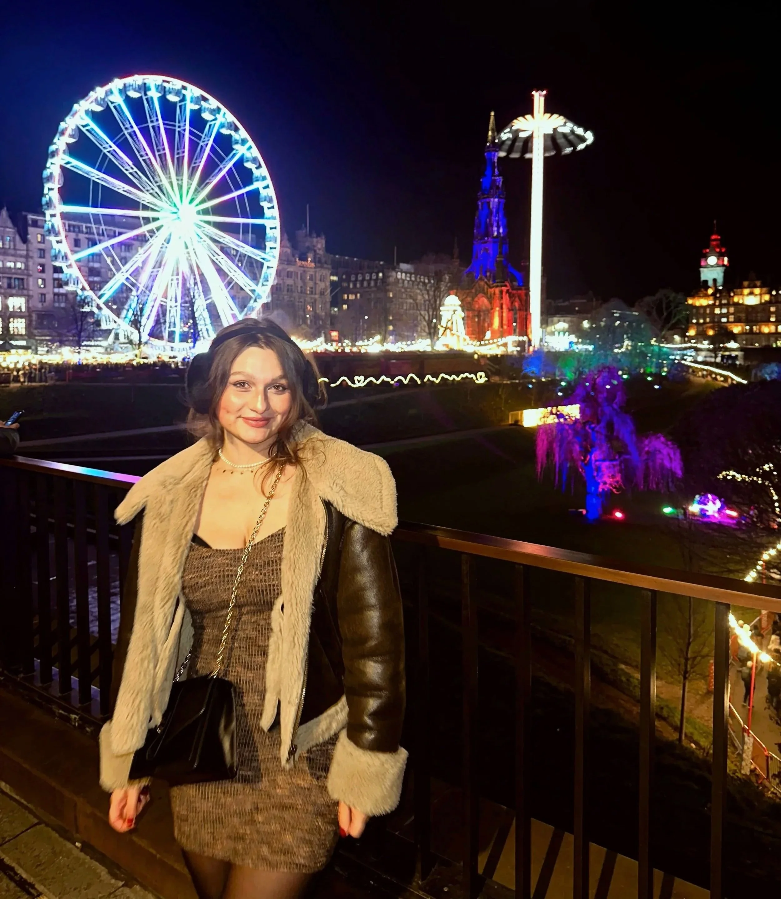 A woman wearing a brown Knit Dress and Zara Aviator Jacket, at Edinburgh Christmas Markets