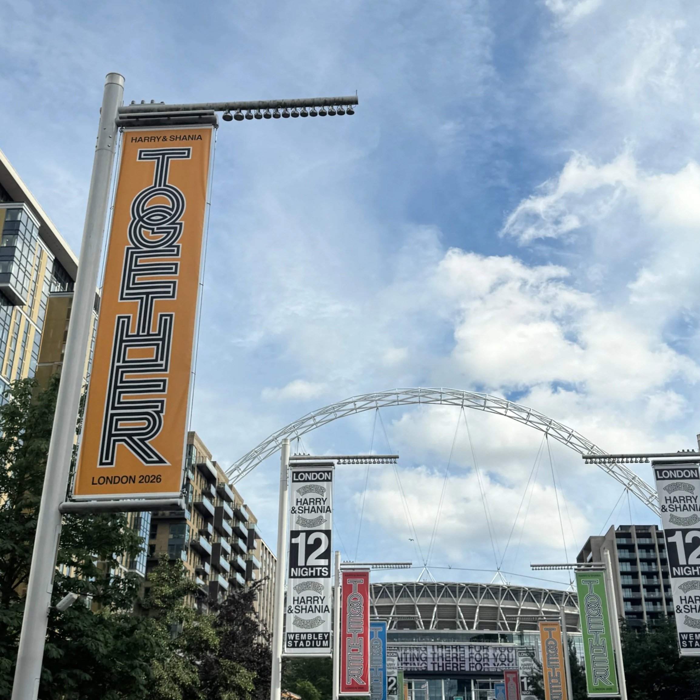 A Together Together banner on Wembley Way for Harry Style's show.