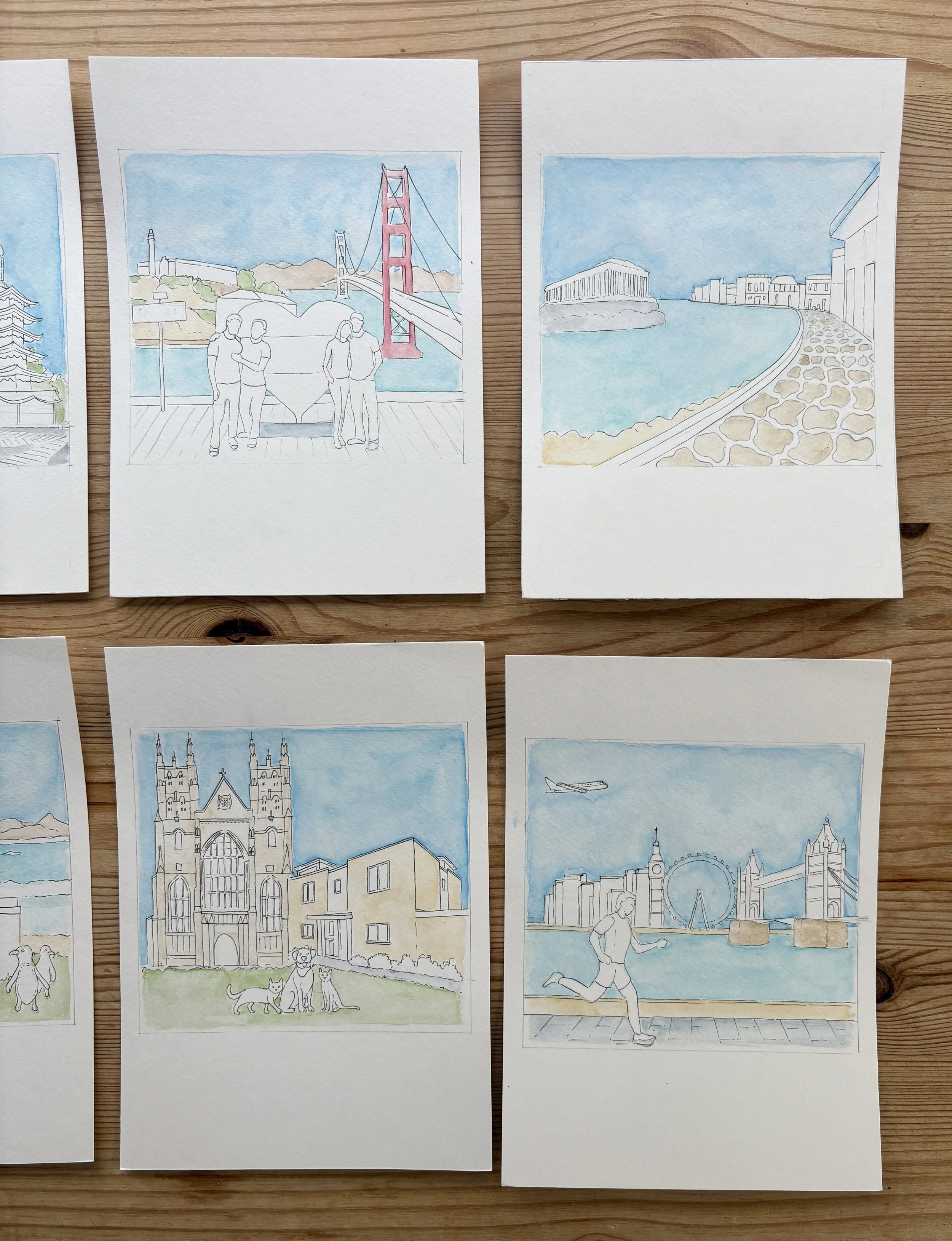 Photo showing how a selection of travel themed scenes are taking shape after the initial colour washes.