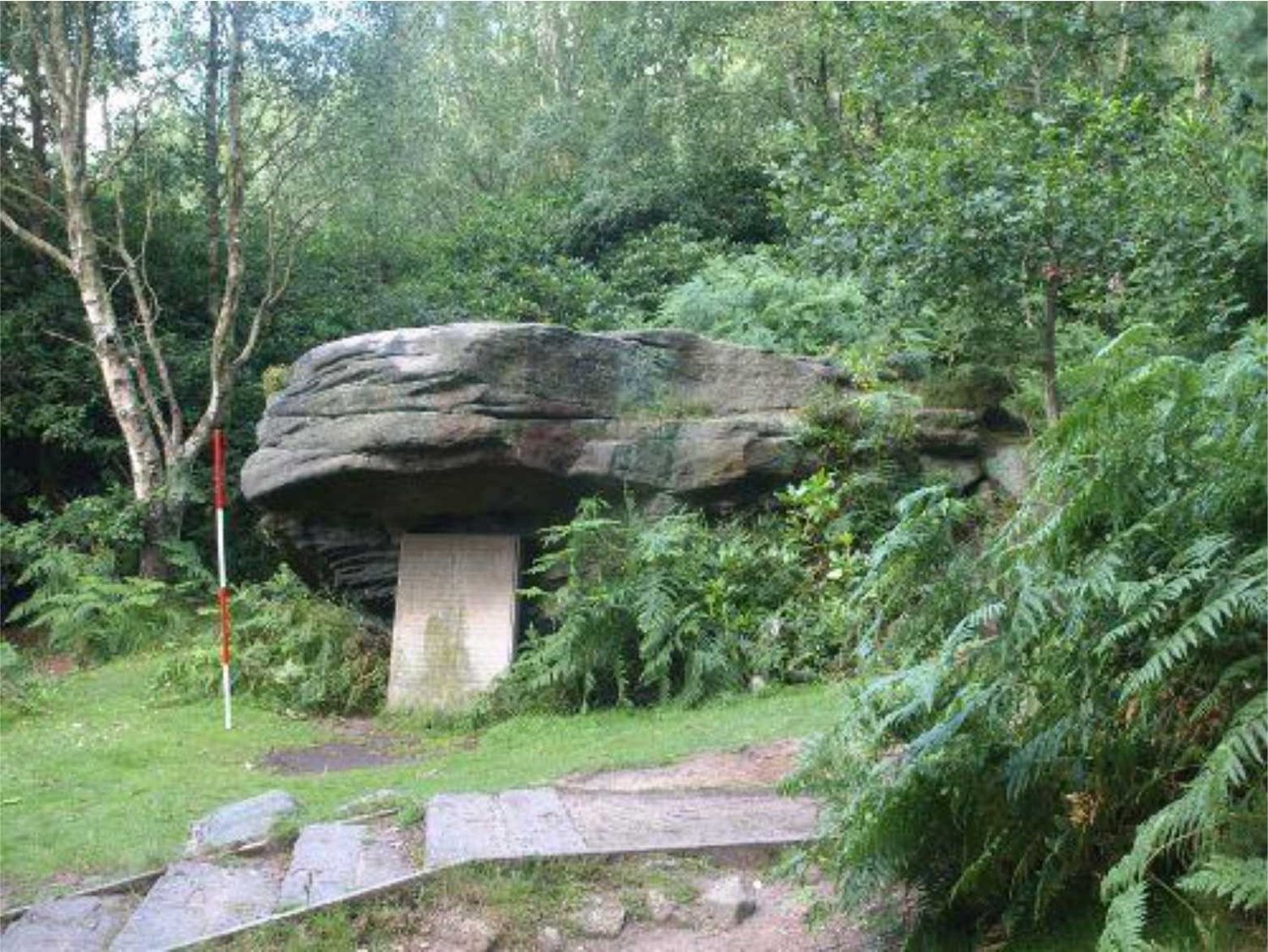 The stone plaque placed under the rock.
