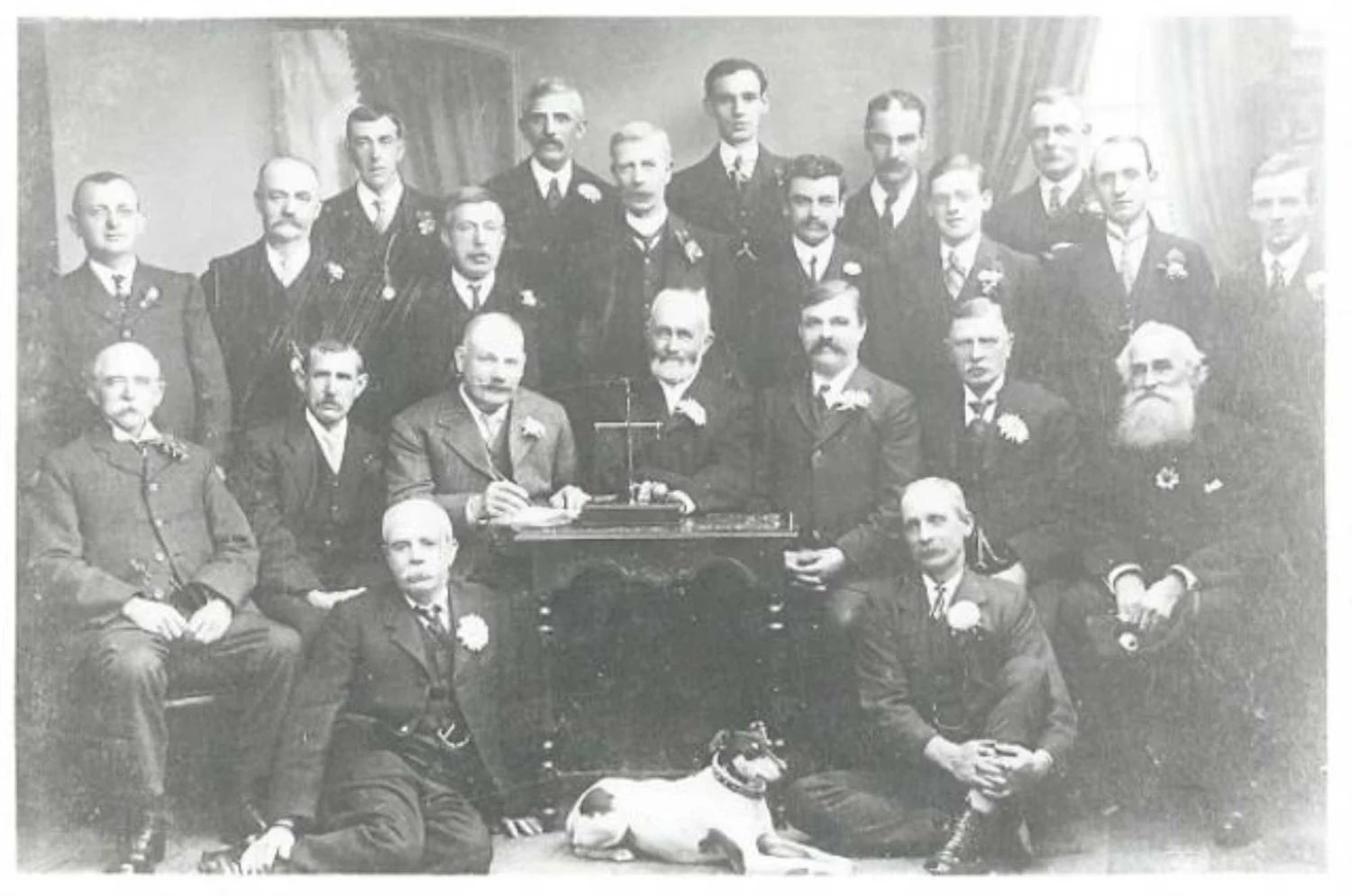 The Bingley Gooseberry Society, from a photograph marked 1913. On the scales is a giant gooseberry.