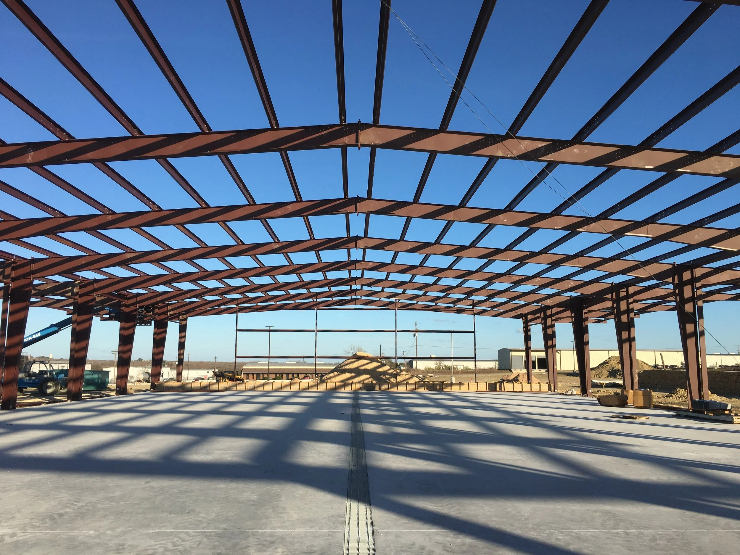 Steel building frame being erected during construction in Central Texas