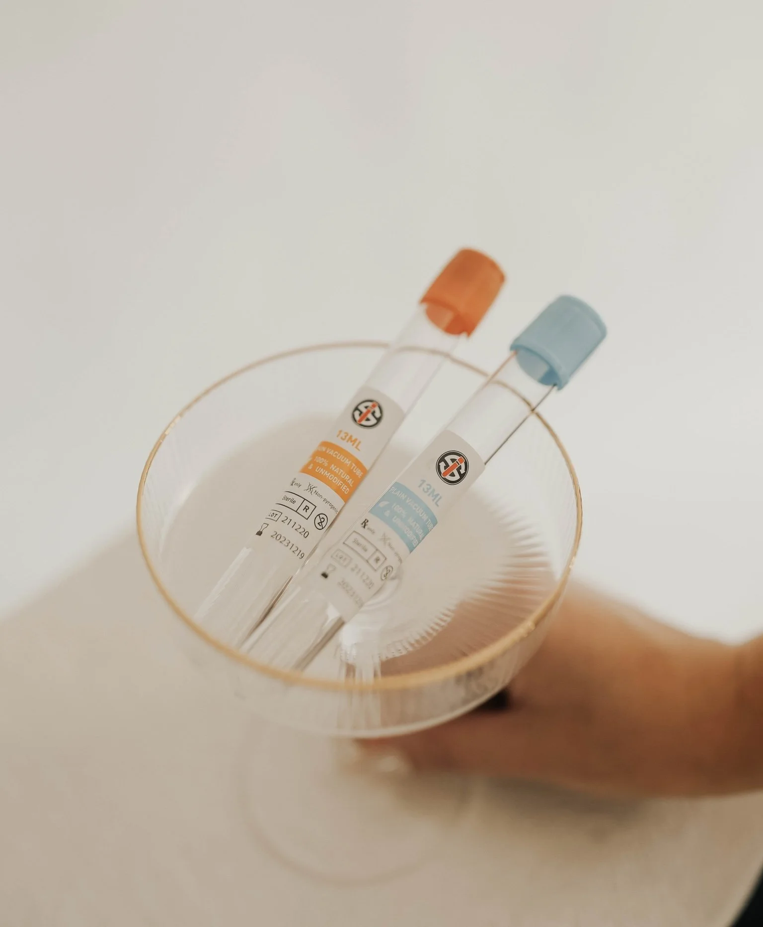 PRF EZ Gel blood draw tubes in a gold-rimmed dish at Golden Aesthetics, used for natural collagen-stimulating skin treatment