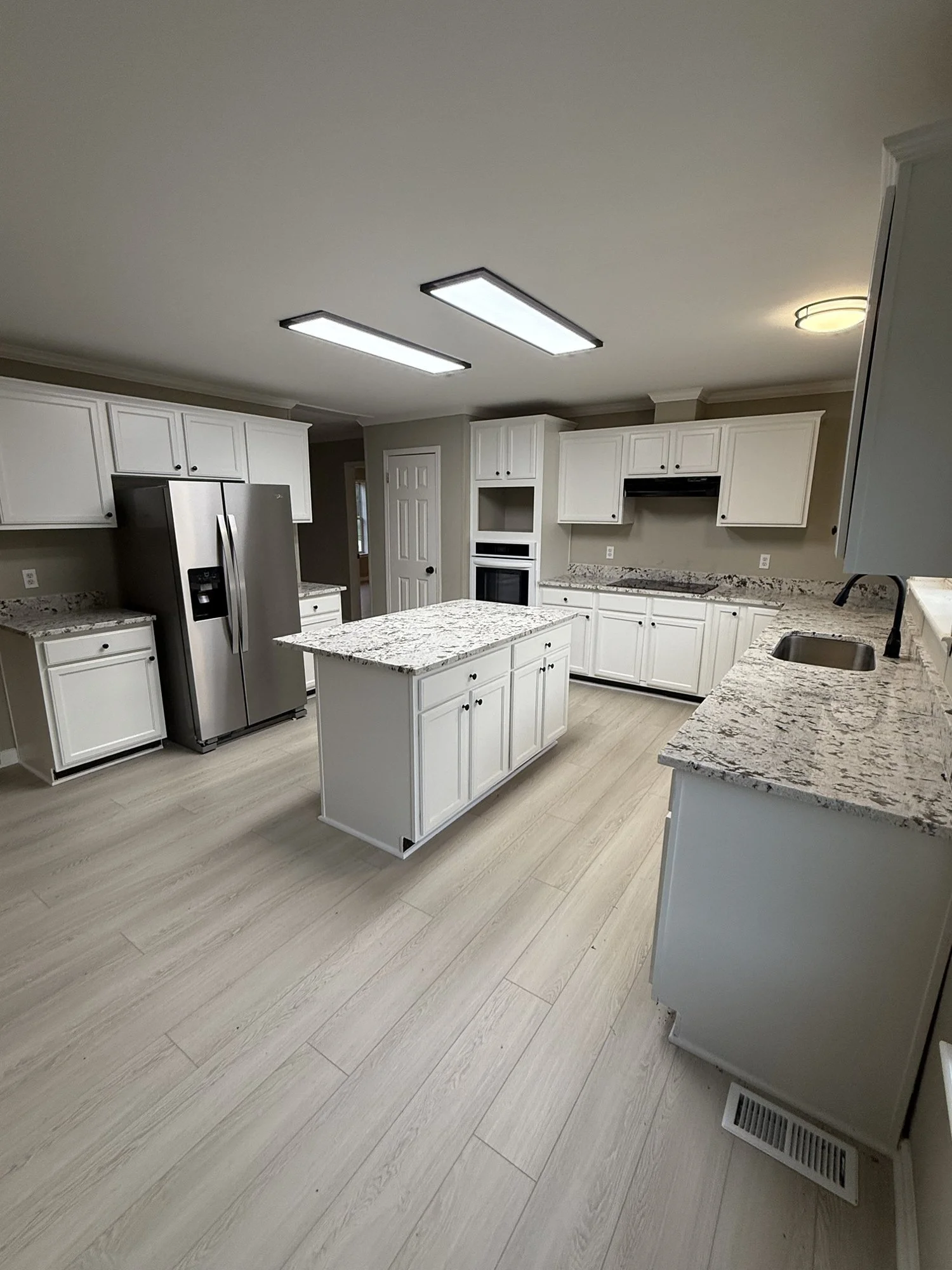 Kitchen remodel: center island, wall oven, new cabinets and flooring.