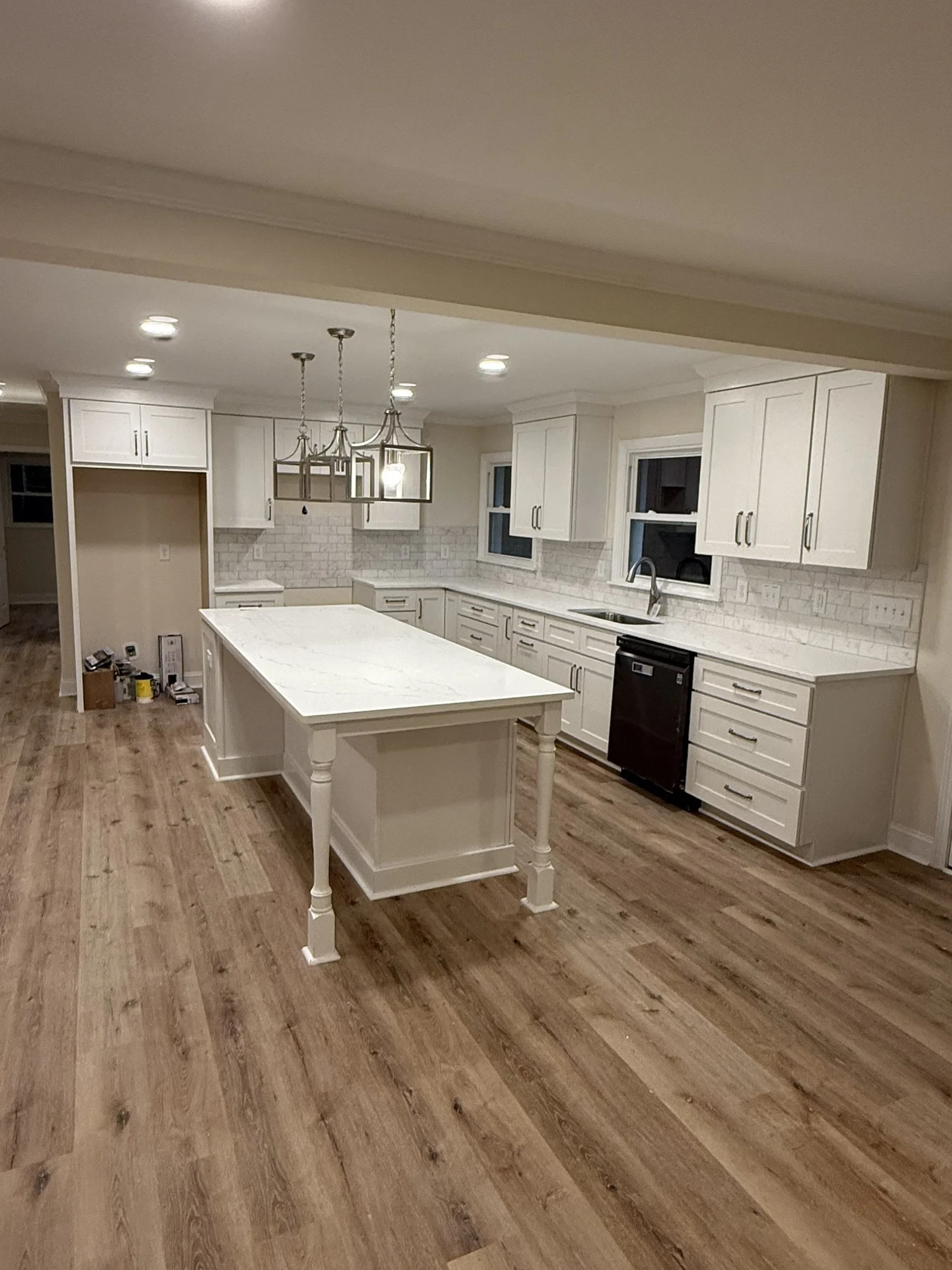 Kitchen remodel by Reign Resolution: island with seating, pendant lighting and white cabinetry