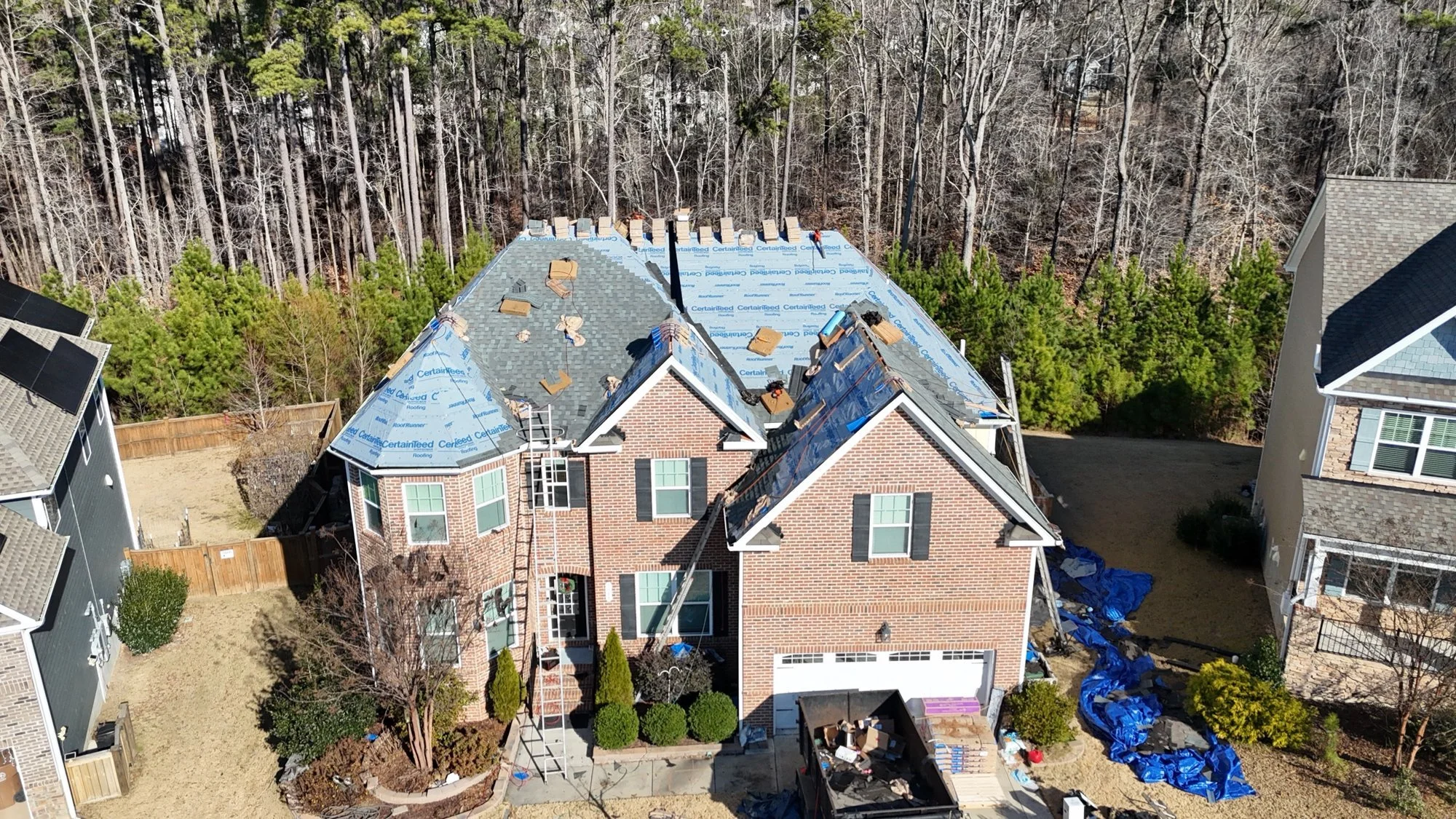 Roof replacement in progress: old shingles removed and new underlayment installed before the new roof goes on.