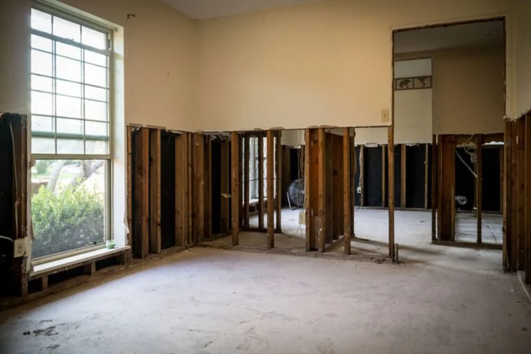 Service illustration: a room with affected lower drywall removed to expose the framing.