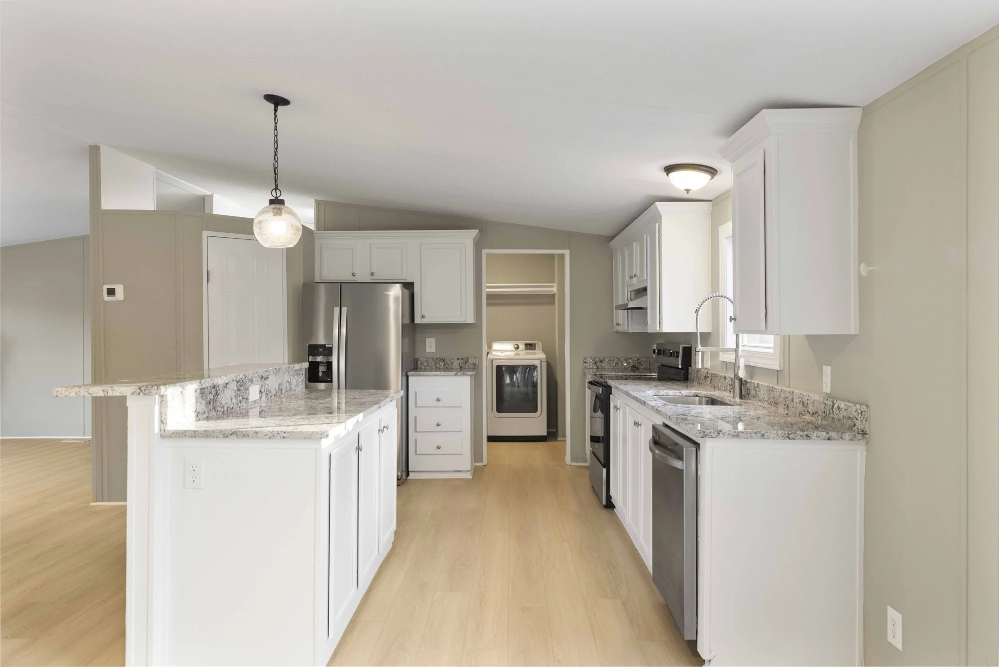 Kitchen remodel: open kitchen with peninsula seating, new cabinets and flooring.