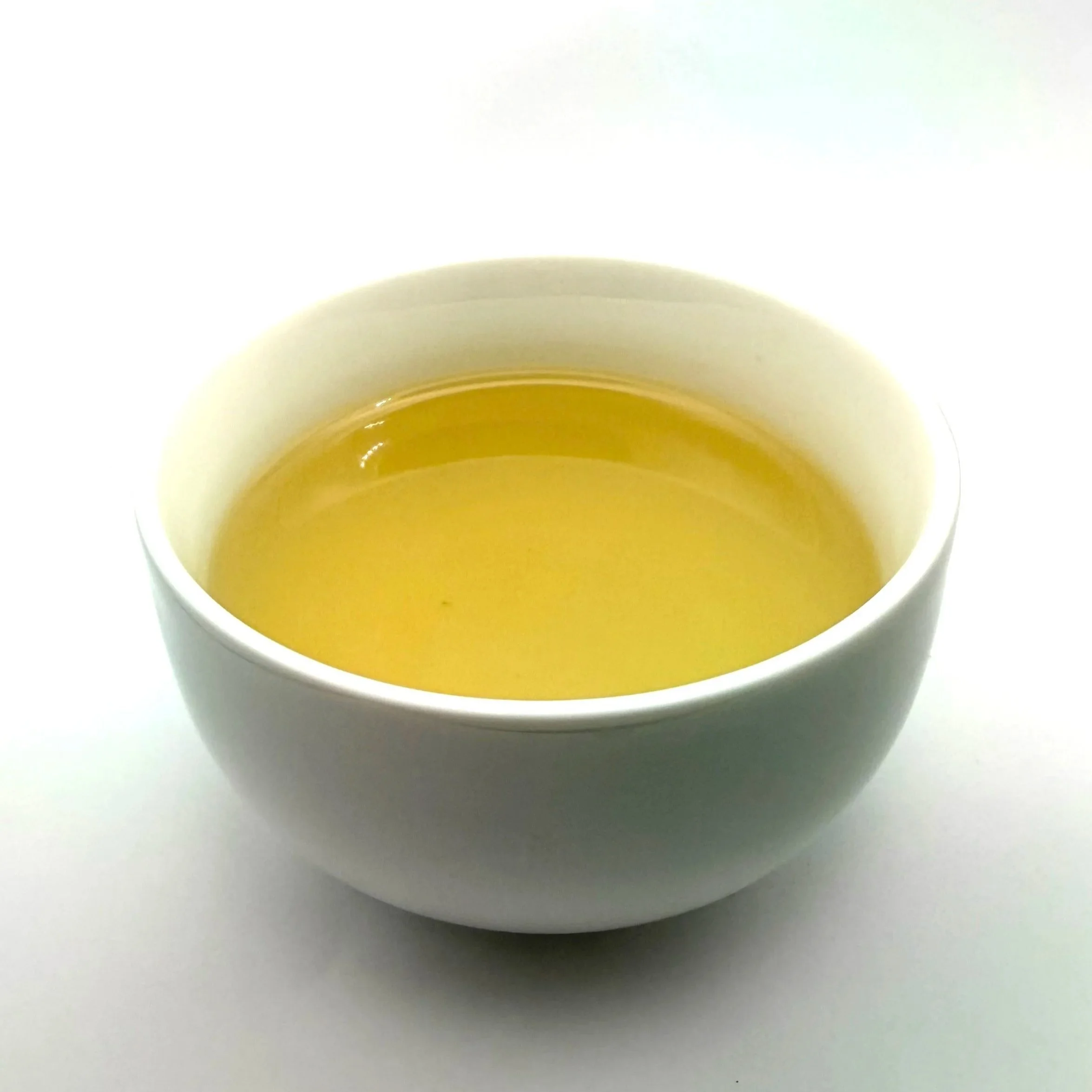 a white bowl of pale yellow Snow Day herbal tea