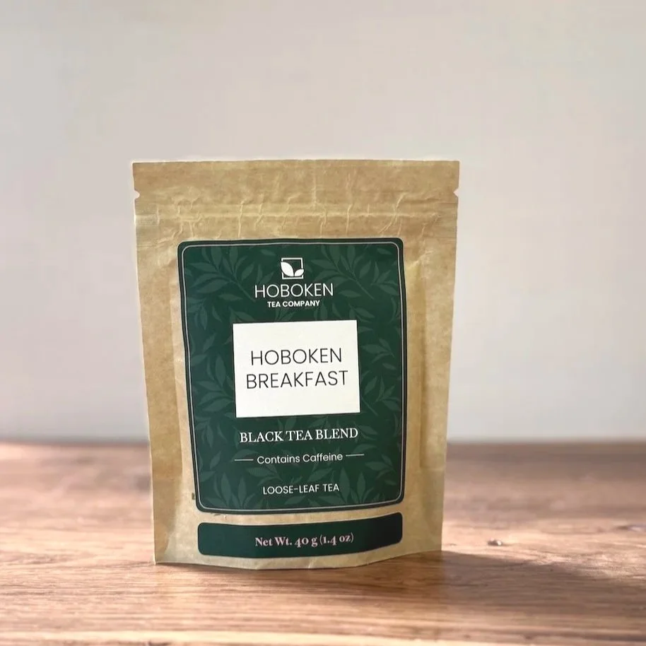 a small package of Hoboken Breakfast loose leaf black tea on a wood table with a white background