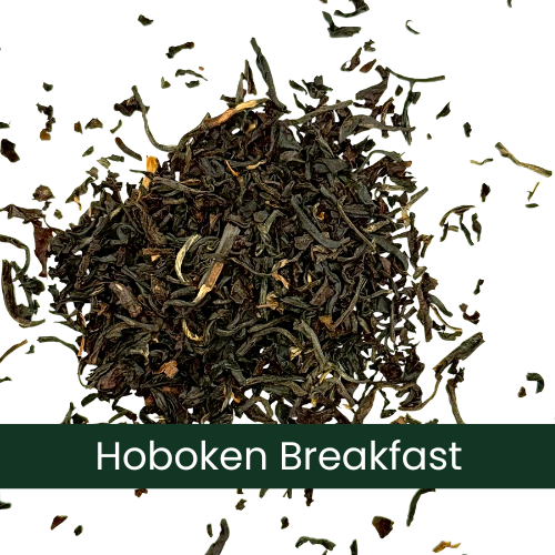 a pile of dry black Hoboken Breakfast tea leaves on a white background