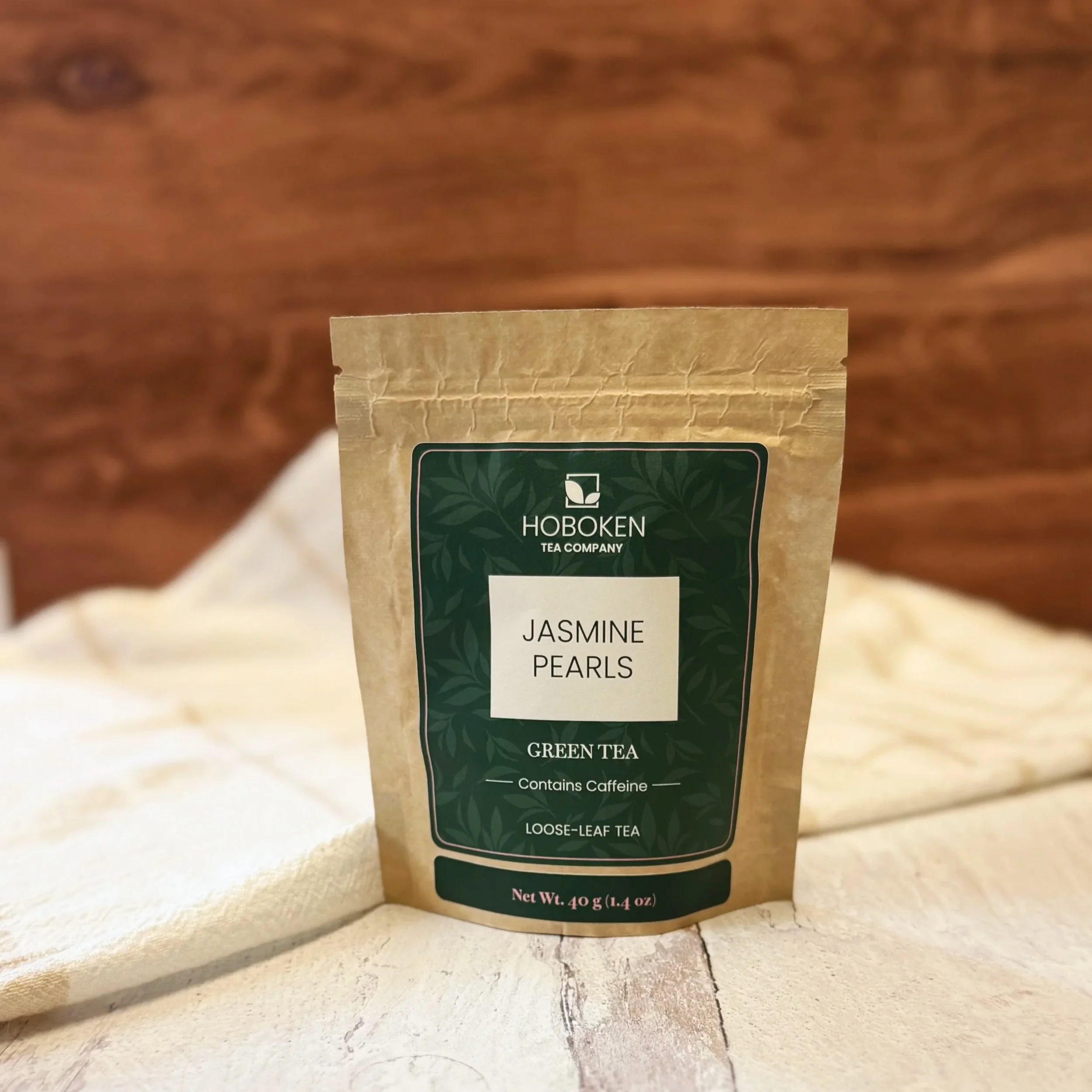a package of loose leaf Jasmine Pearls green tea from Hoboken Tea Company on a table