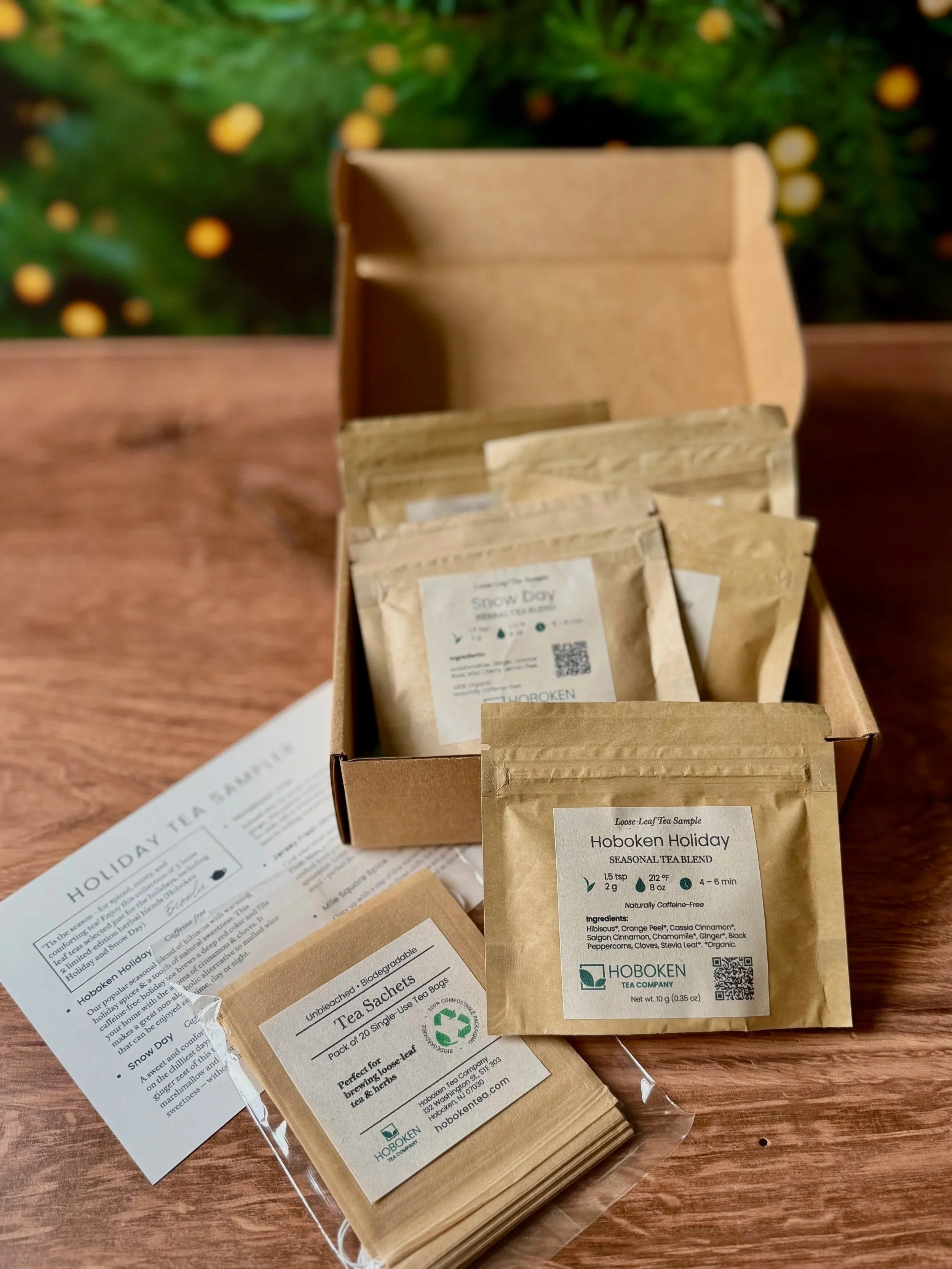 An open box containing several small packets of loose leaf tea