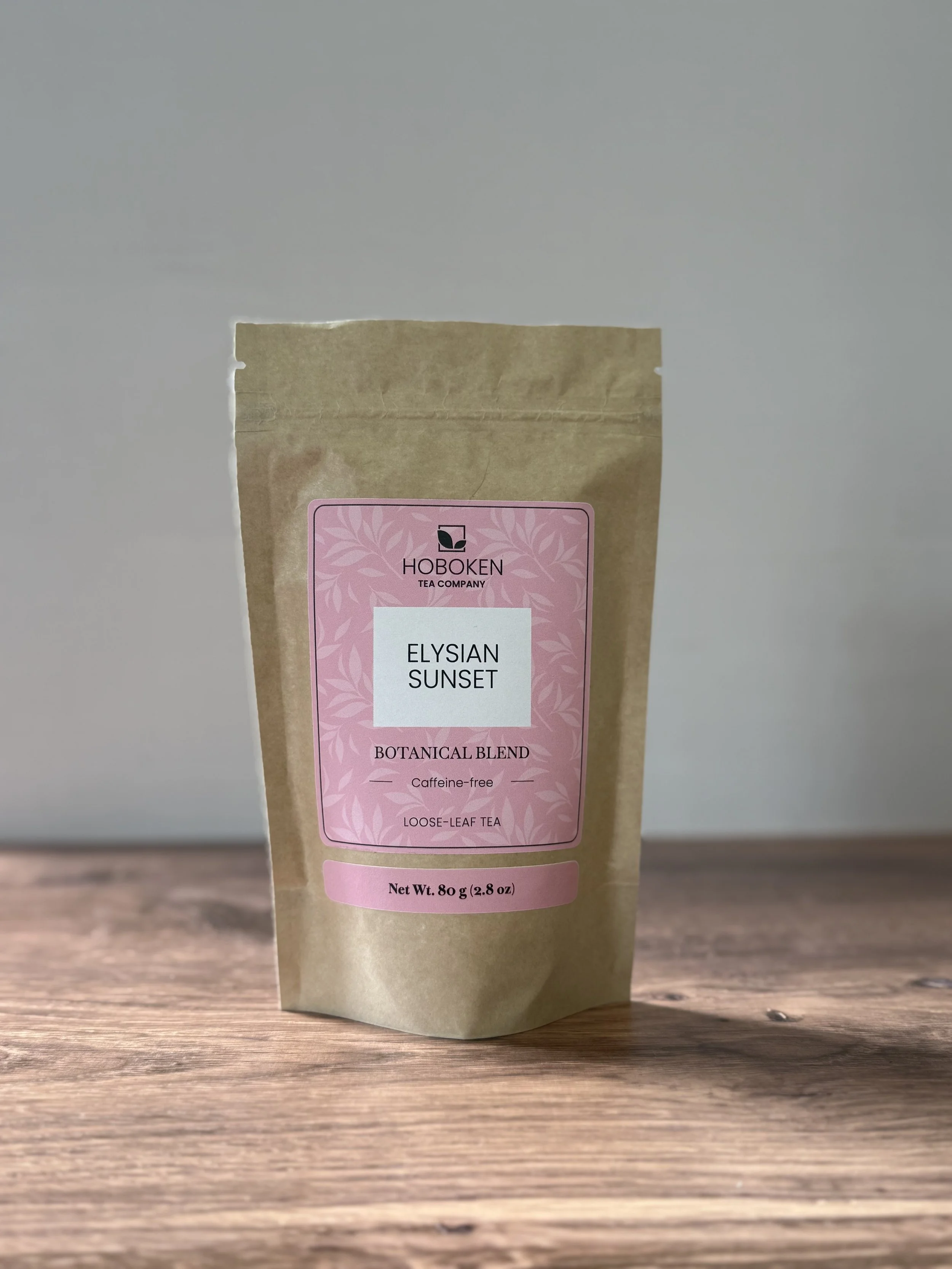 a pouch of Elysian Sunset loose leaf ginger-turmeric tea on a table