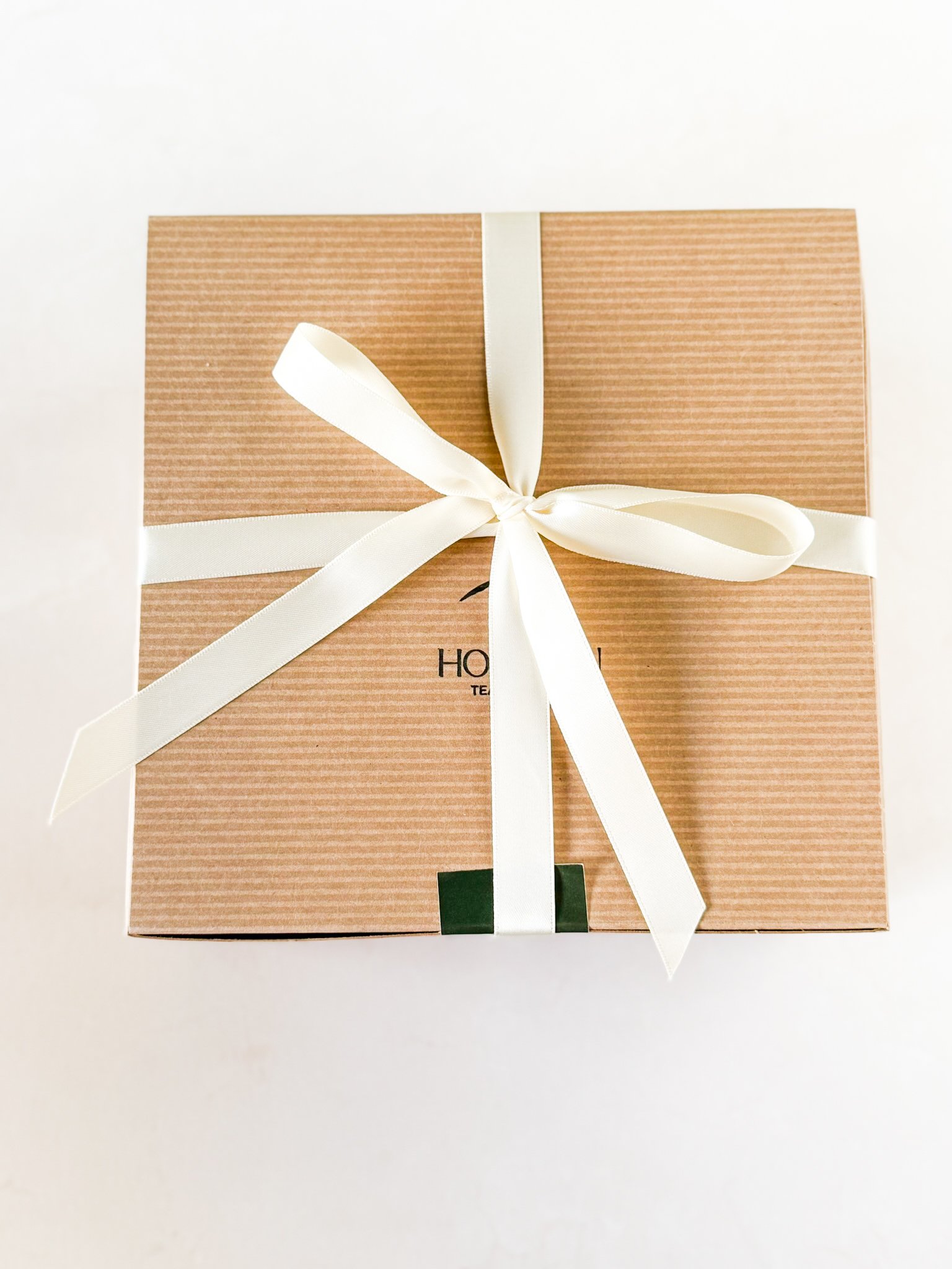a Kraft paper gift box tied with a white ribbon
