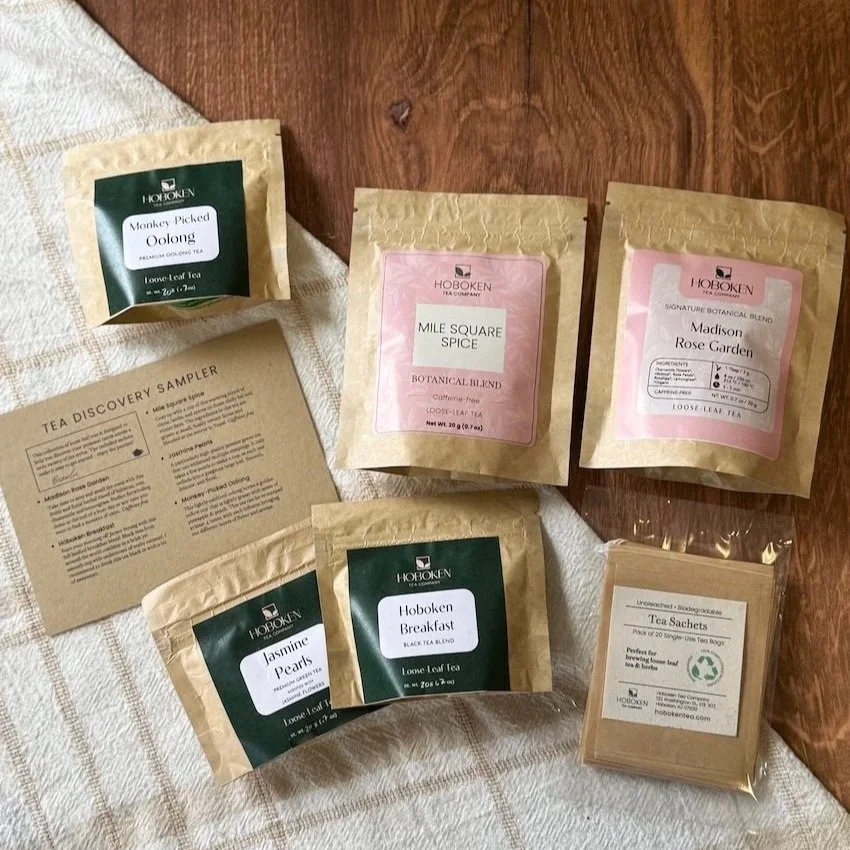 various packets of loose leaf tea and a pack of biodegradable paper filter bags
