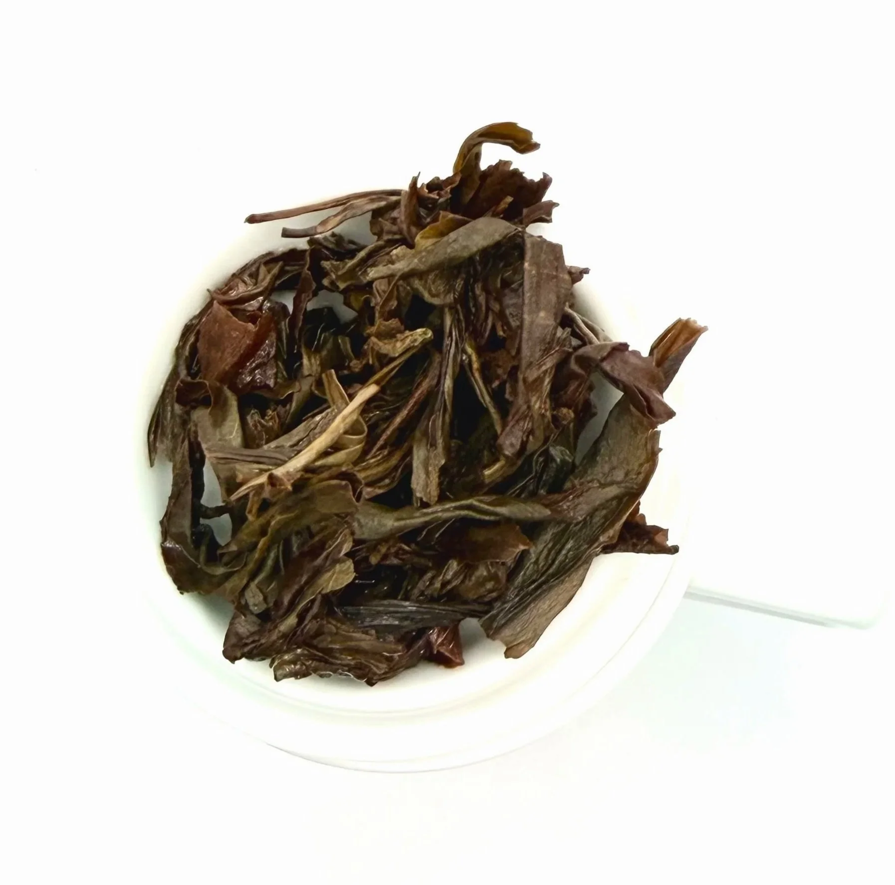 dark oolong tea leaves on a white background