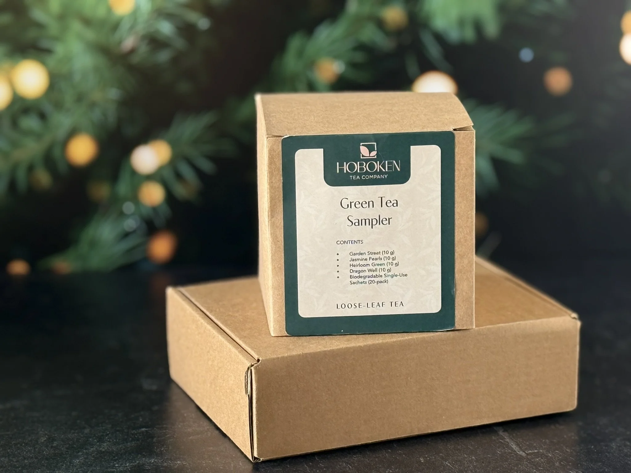 Boxed Hoboken Tea Company green tea sample gift in front of a Christmas tree