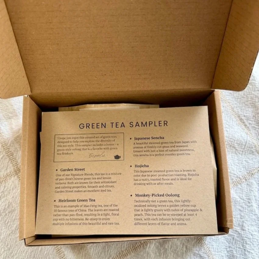 an open cardboard box with a notecard inside