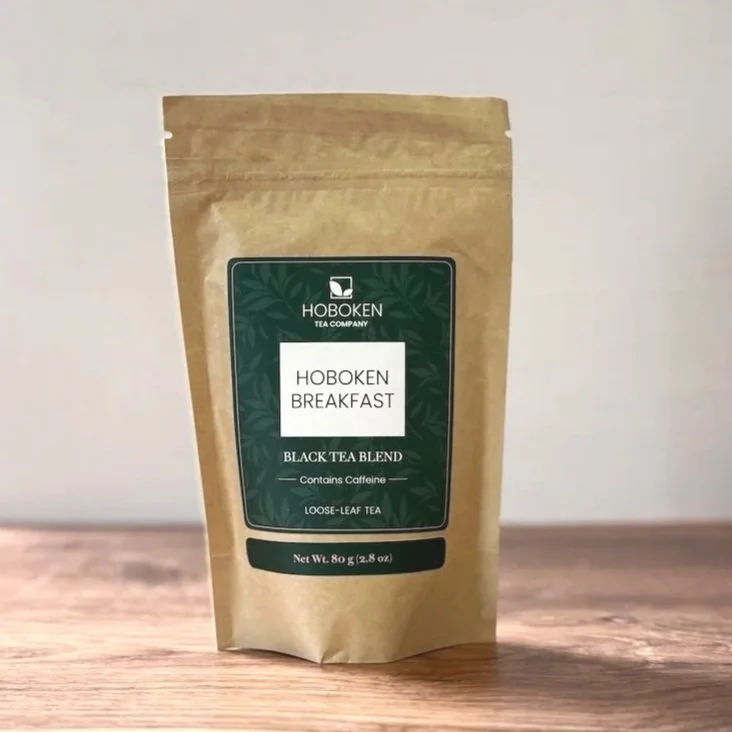 a large package of Hoboken Breakfast loose leaf black tea on a wood table with a white background