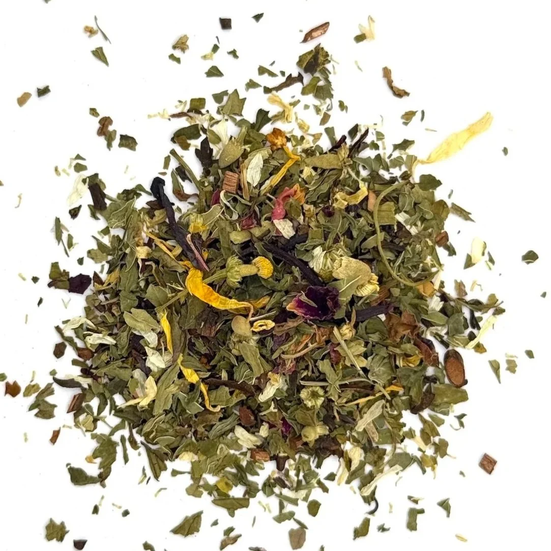 a pile of loose leaf herbal tea with mint, hibiscus, and flower petals