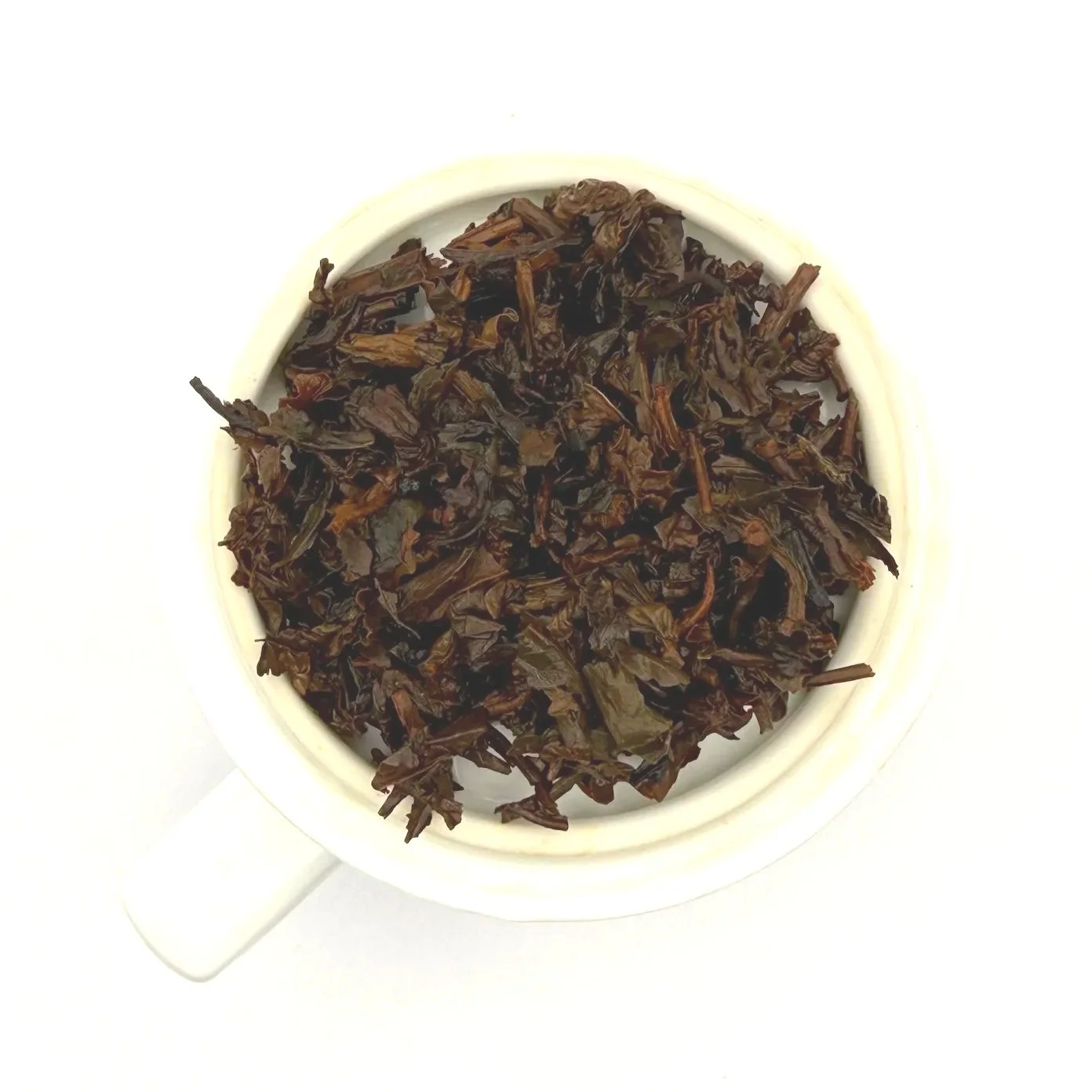 a closeup of oolong tea leaves after steeping and straining on a white background