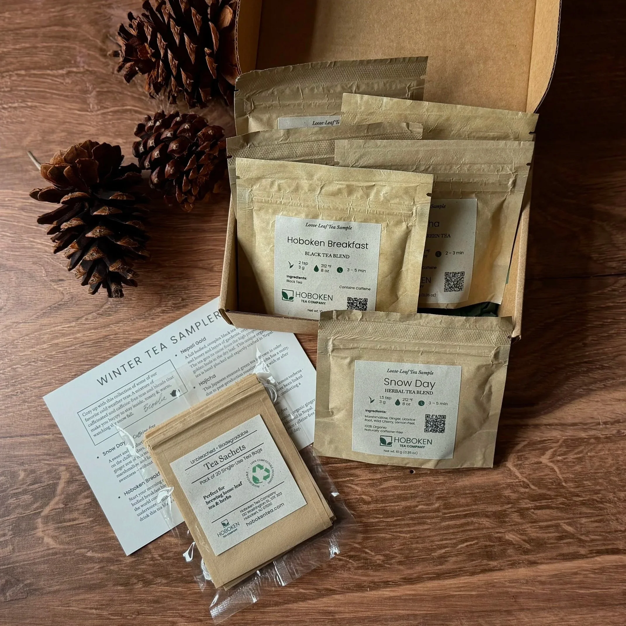 An open box containing several small packets of loose leaf tea