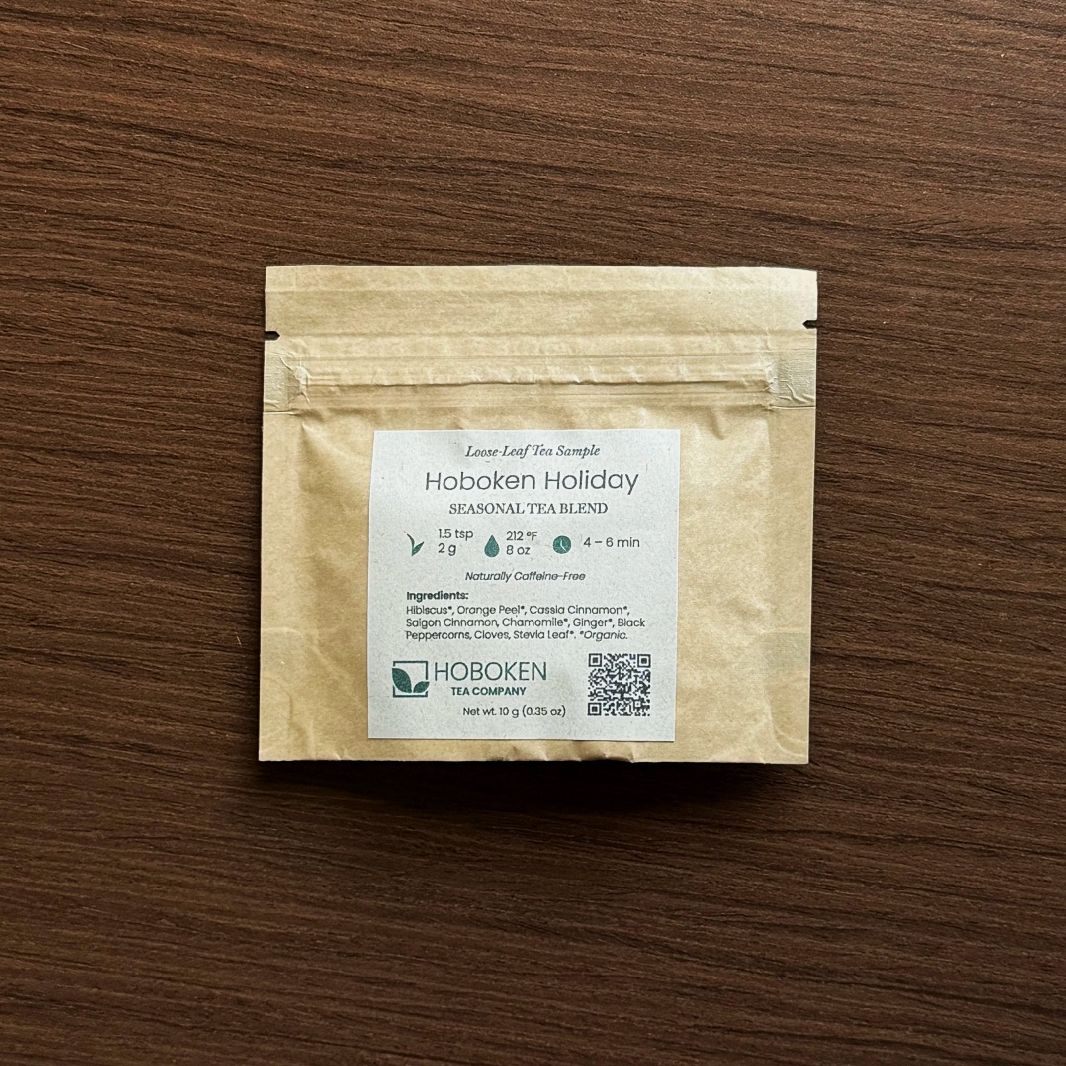 A small packet of loose leaf tea labeled Hoboken Holiday with the Hoboken Tea Company logo