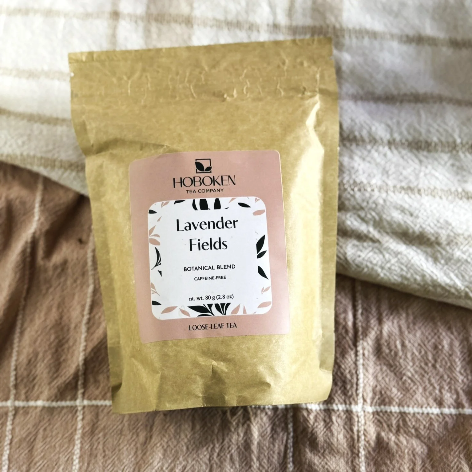 A package of Lavender Fields loose-leaf herbal tea on a pink linen cloth