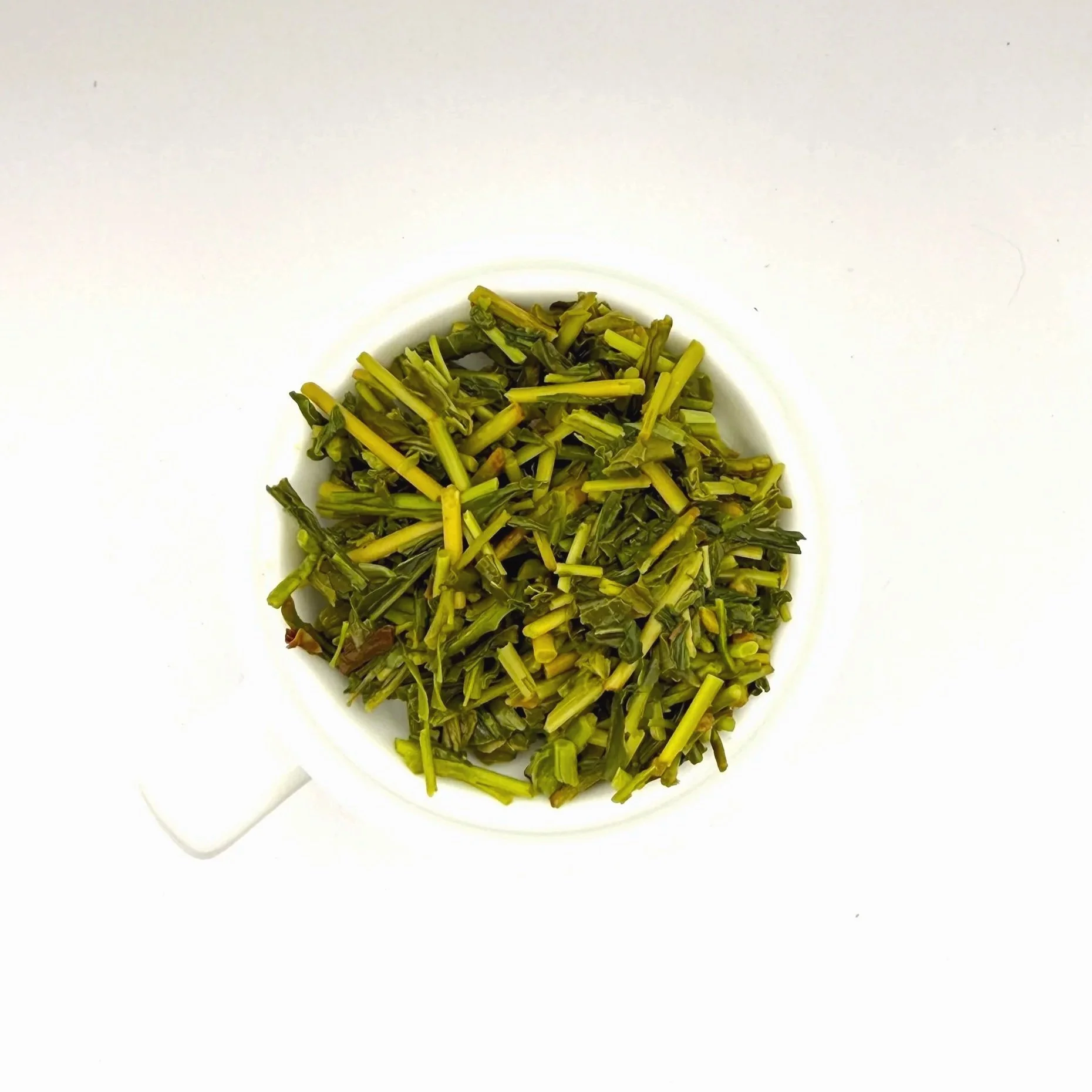 a closeup of kukicha green tea leaves after steeping and straining