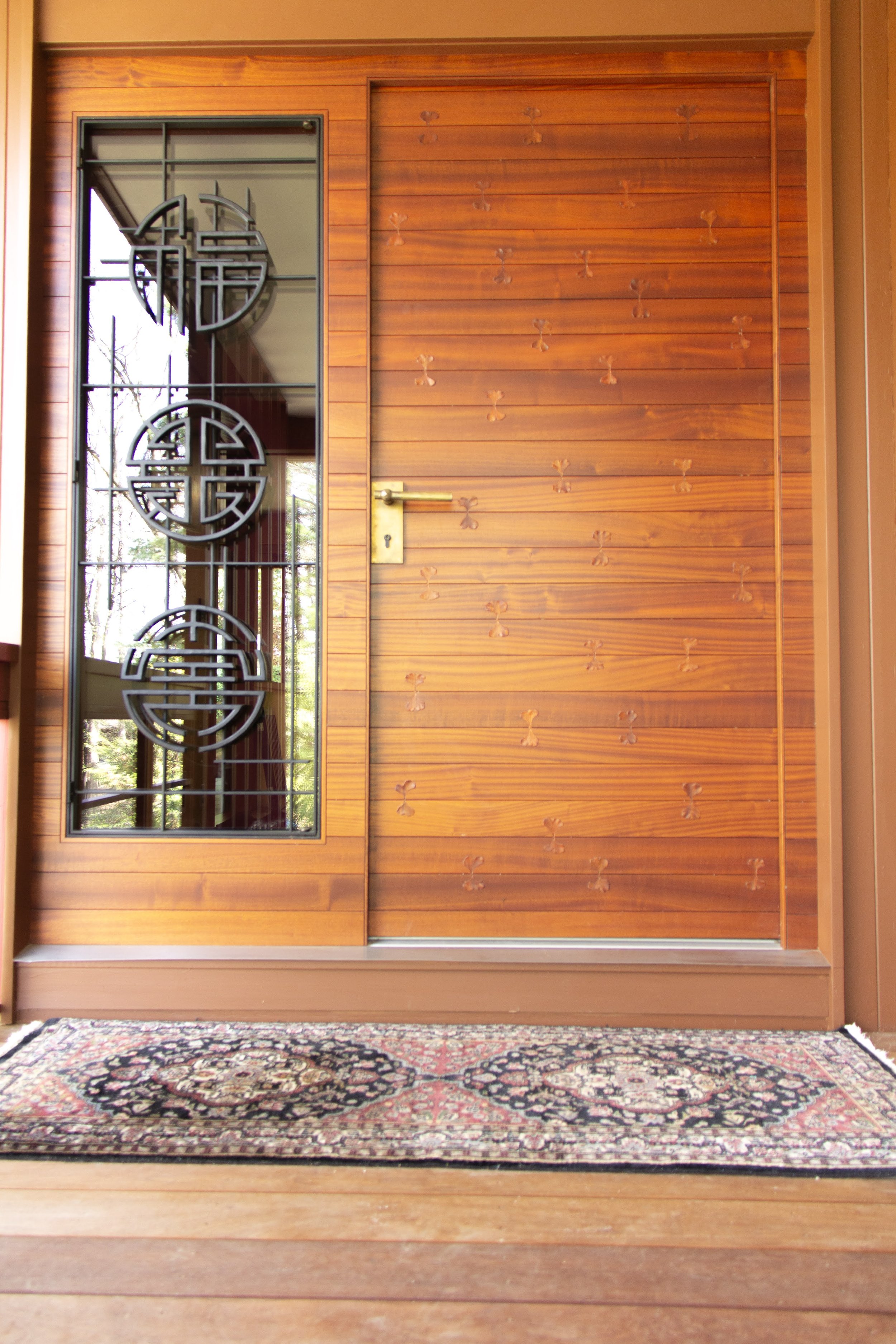 Door with ginkgo leaf inlays and symbolic metal work