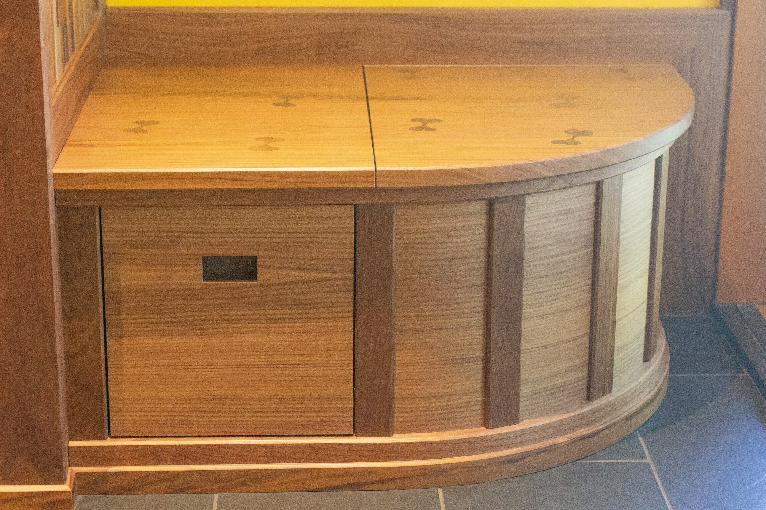 ... bringing the ginkgo leaf theme from the door to a seating bench in the kitchen